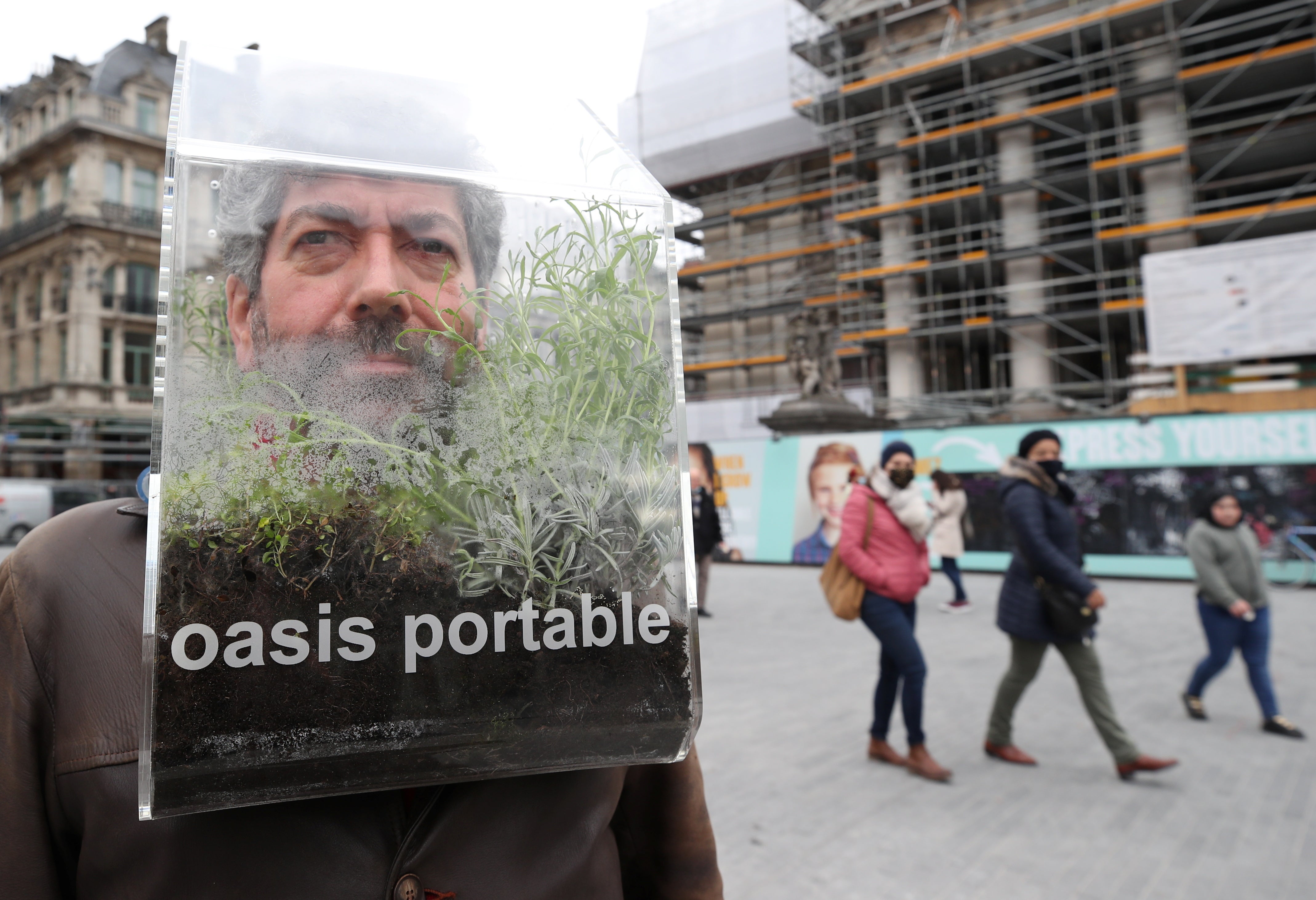 Belgian artist Alain Verschueren wears his “Portable Oasis”
