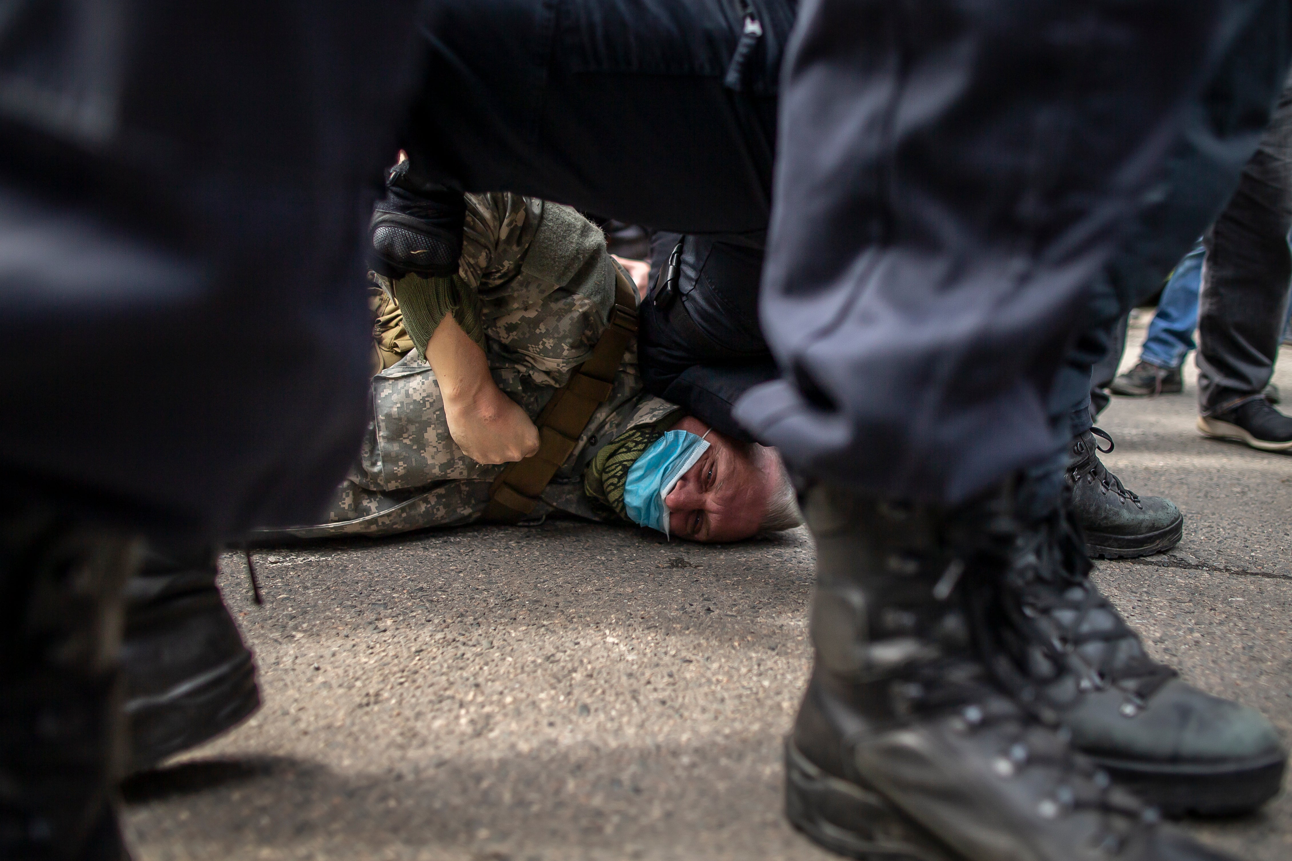 Police officers detain a pro-Russian sympathiser during a protest in Prague