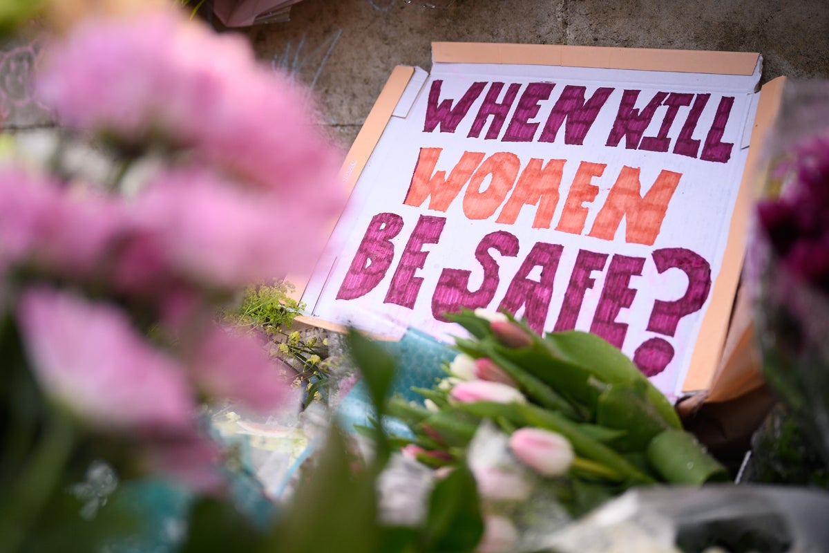 A message is seen among the flowers on Clapham Common where floral tributes were placed for Sarah Everard