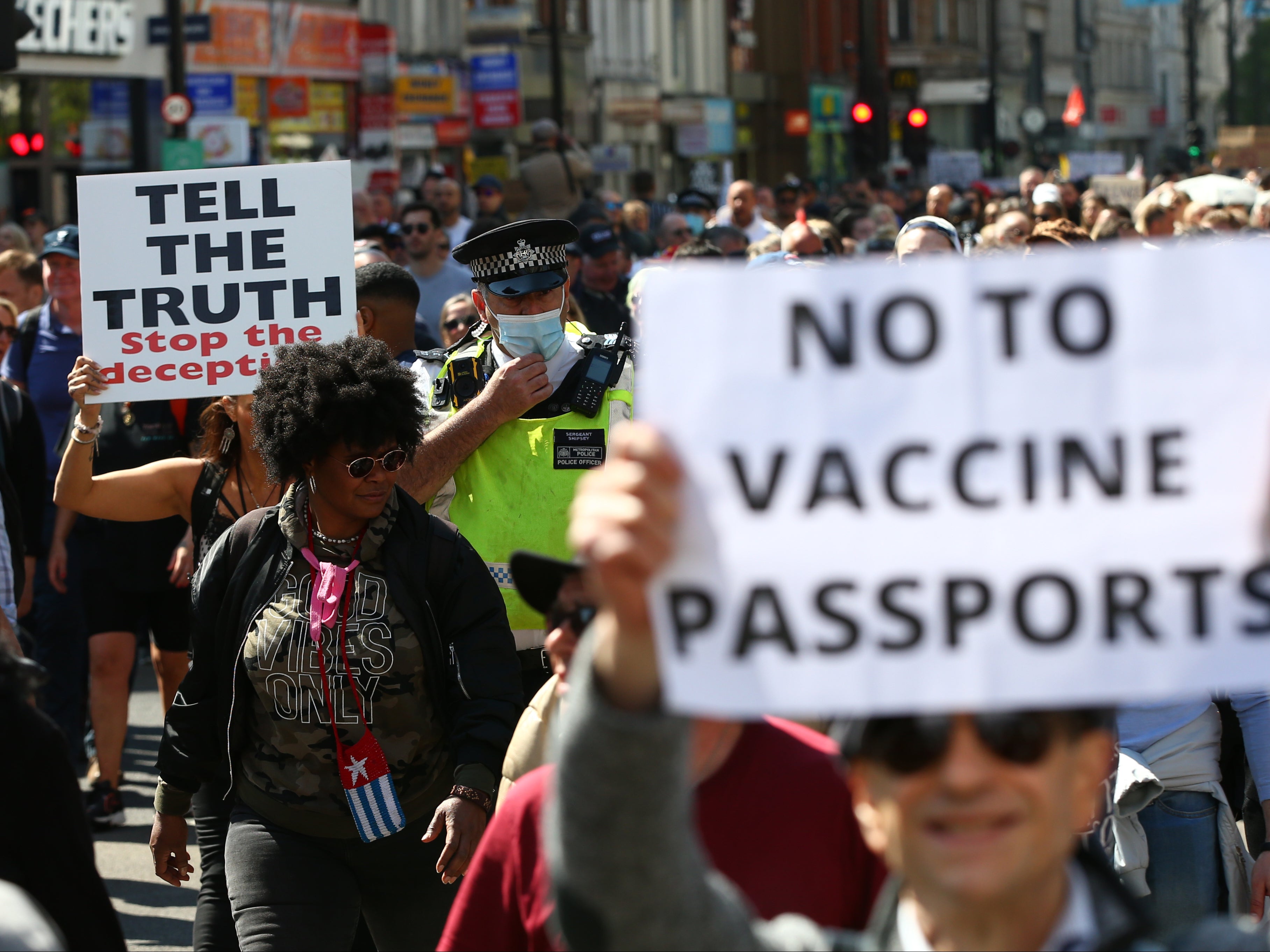 A Met Police officer walks amongst protestors during a ‘Unite For Freedom' anti-lockdown demonstration