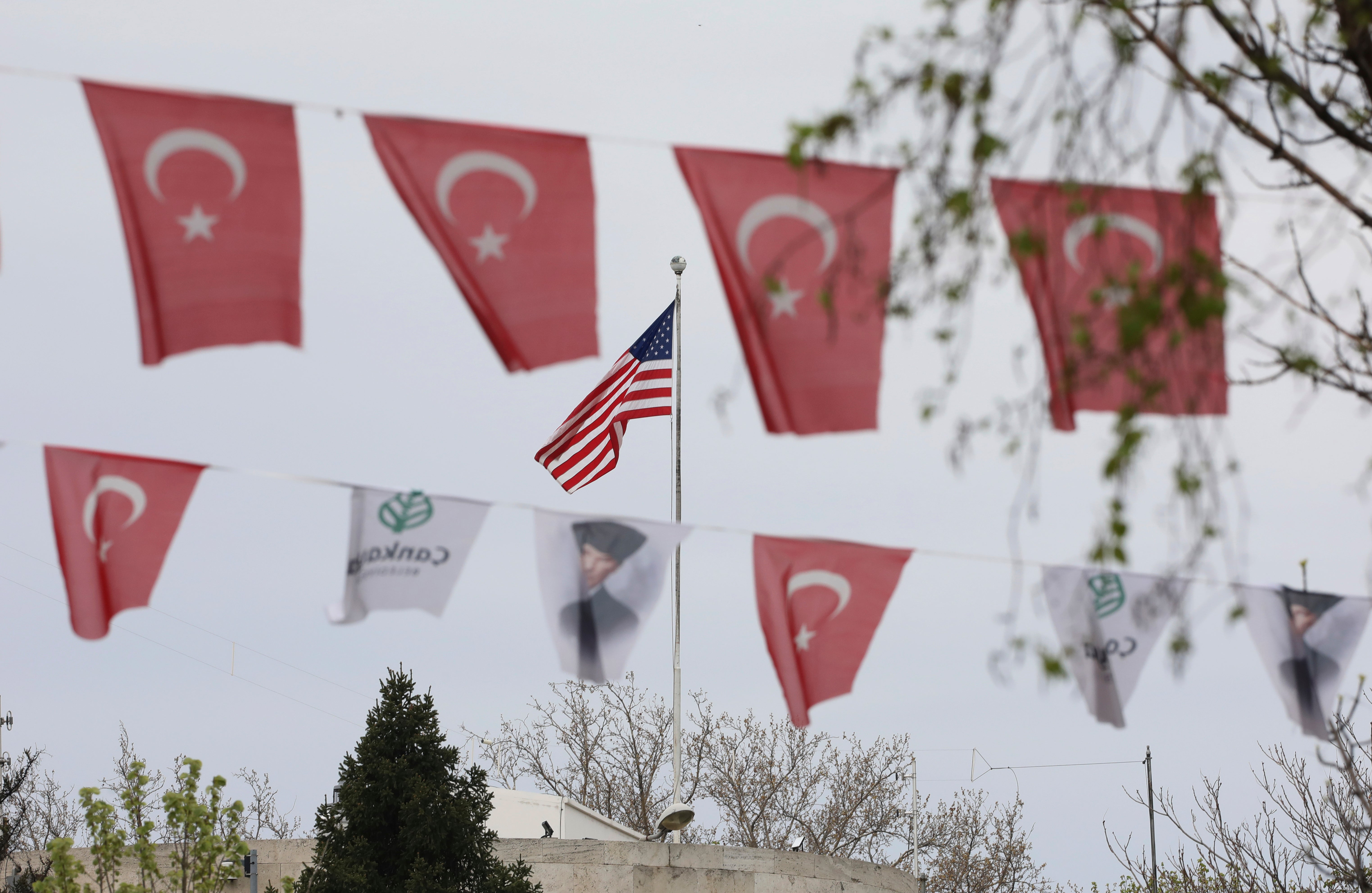 Turkish flags and banners depicting Mustafa Kemal Ataturk, the founder of modern Turkey, decorate a street outside the United States embassy in Ankara on Sunday (25 April)