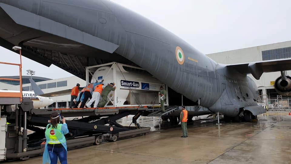 An oxygen tank is loaded onto an aircraft to supply hospitals in India, at Changi Airport in Singapore