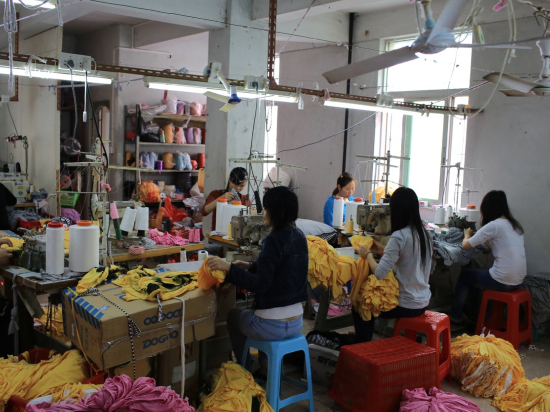 Garment workers work in a small clothing factory in China. A cross-party group of MPs and peers are calling on fast fashion giants to do more to ensure garment workers in their supply chains can earn a living wage