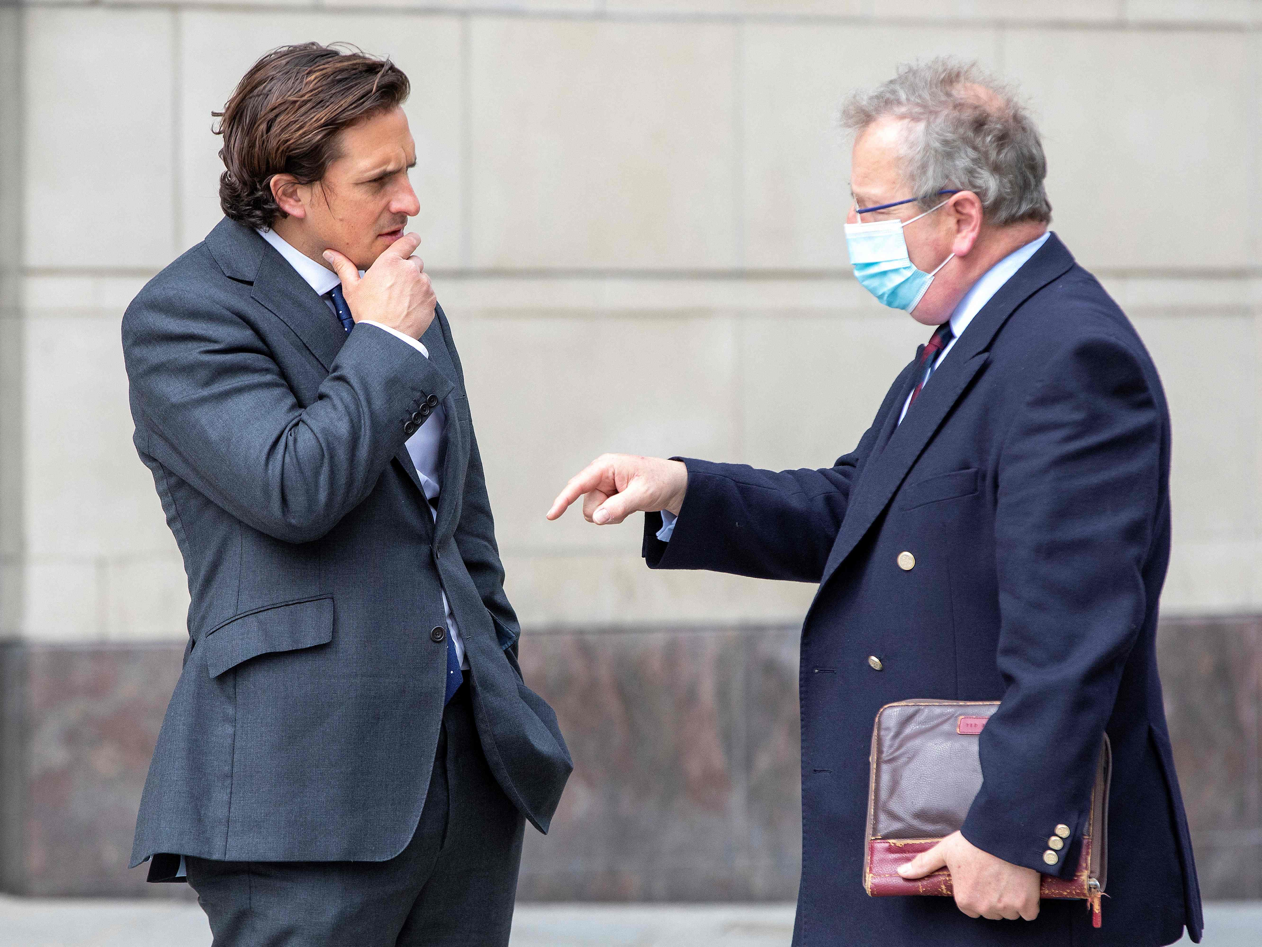 Former veterans minister Johnny Mercer (left) talks with Northern Ireland veterans commissioner Danny Kinahan outside Belfast Crown Court