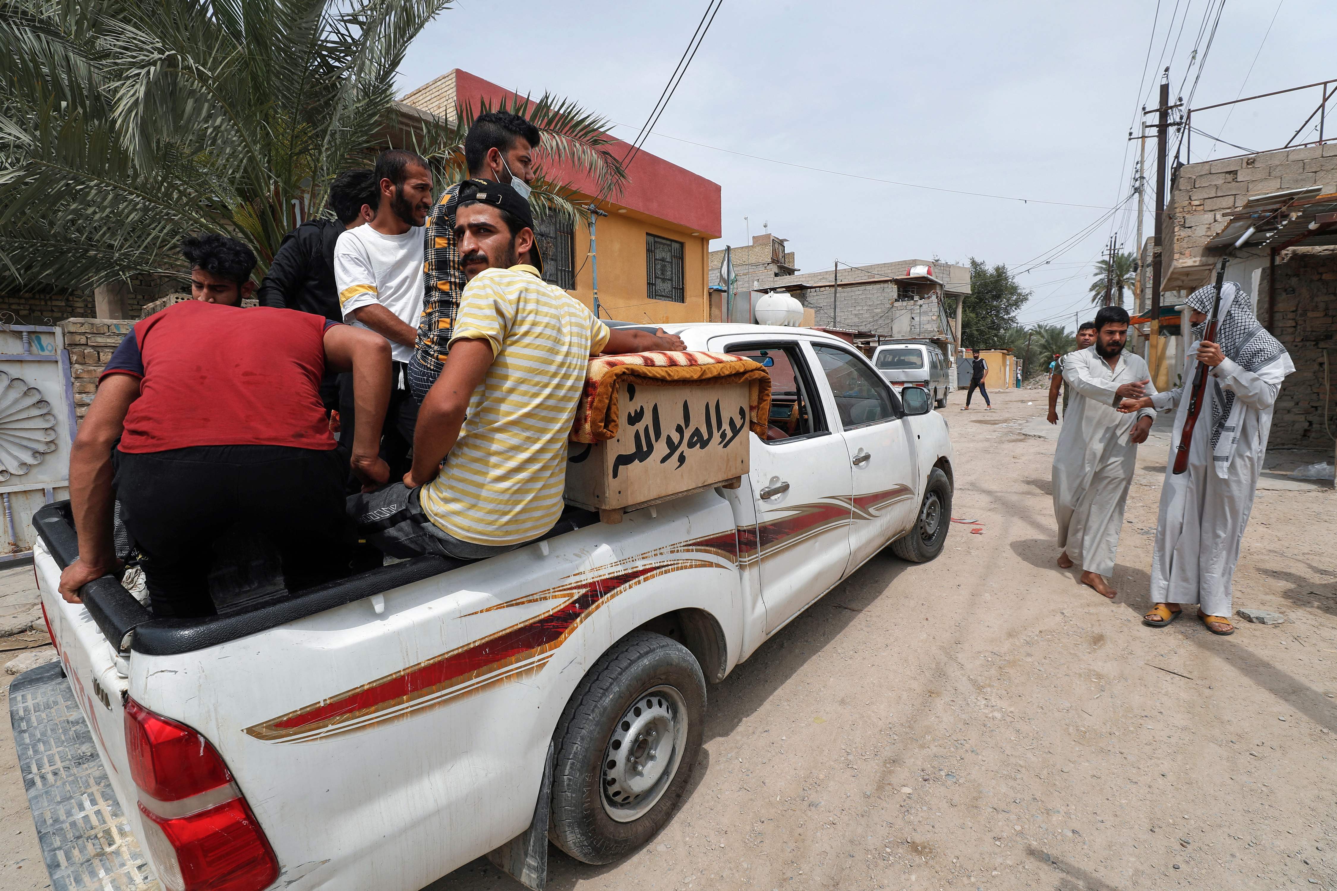 The coffin of a relative who was killed during a fire at the Ibn Khatib hospital, Baghdad, reserved for the most severe Covid-19 cases, is removed for burial