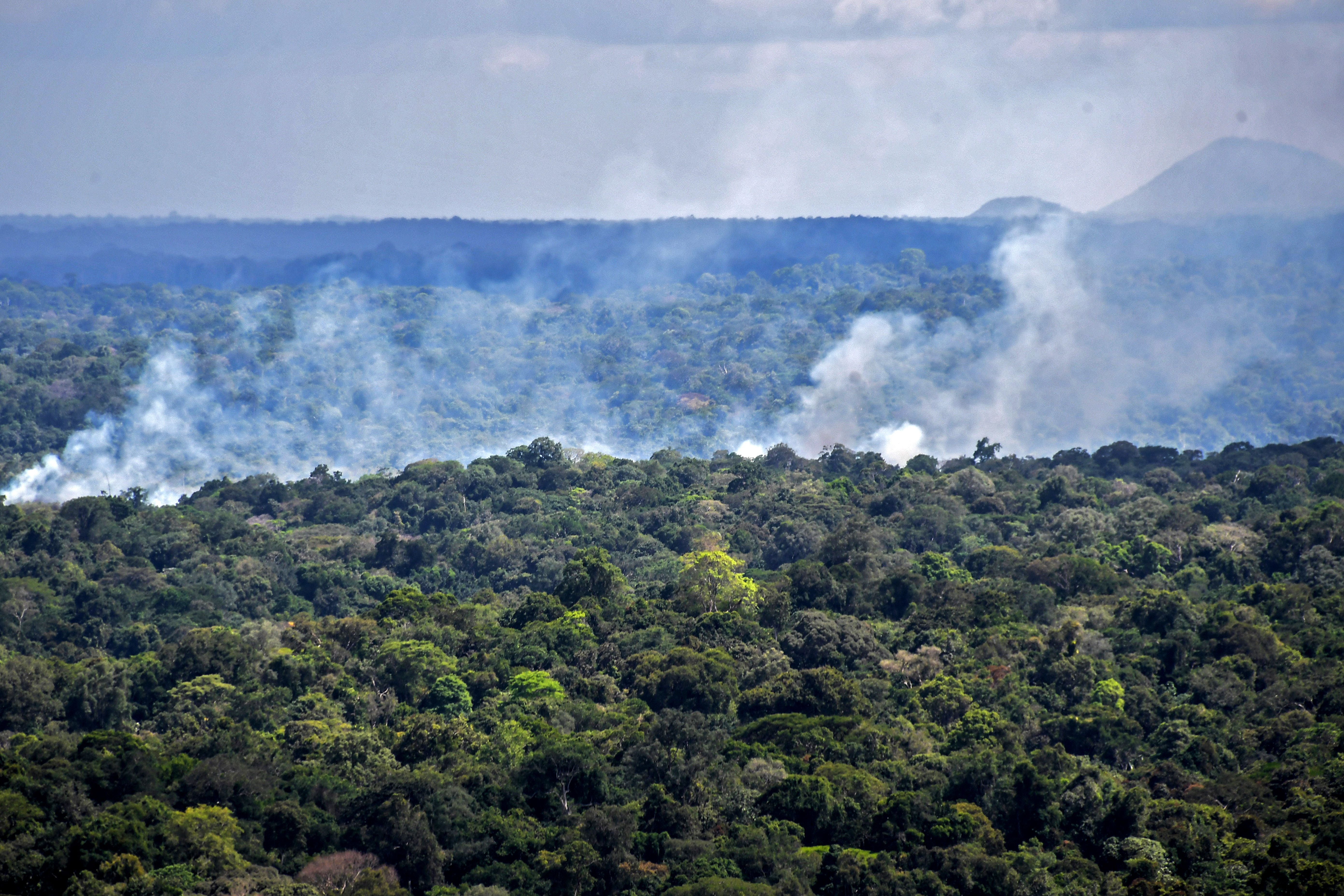 Aerial view showing smoke from a fire billowing from the Amazon rainforest in Oiapoque, Amapa state, Brazil