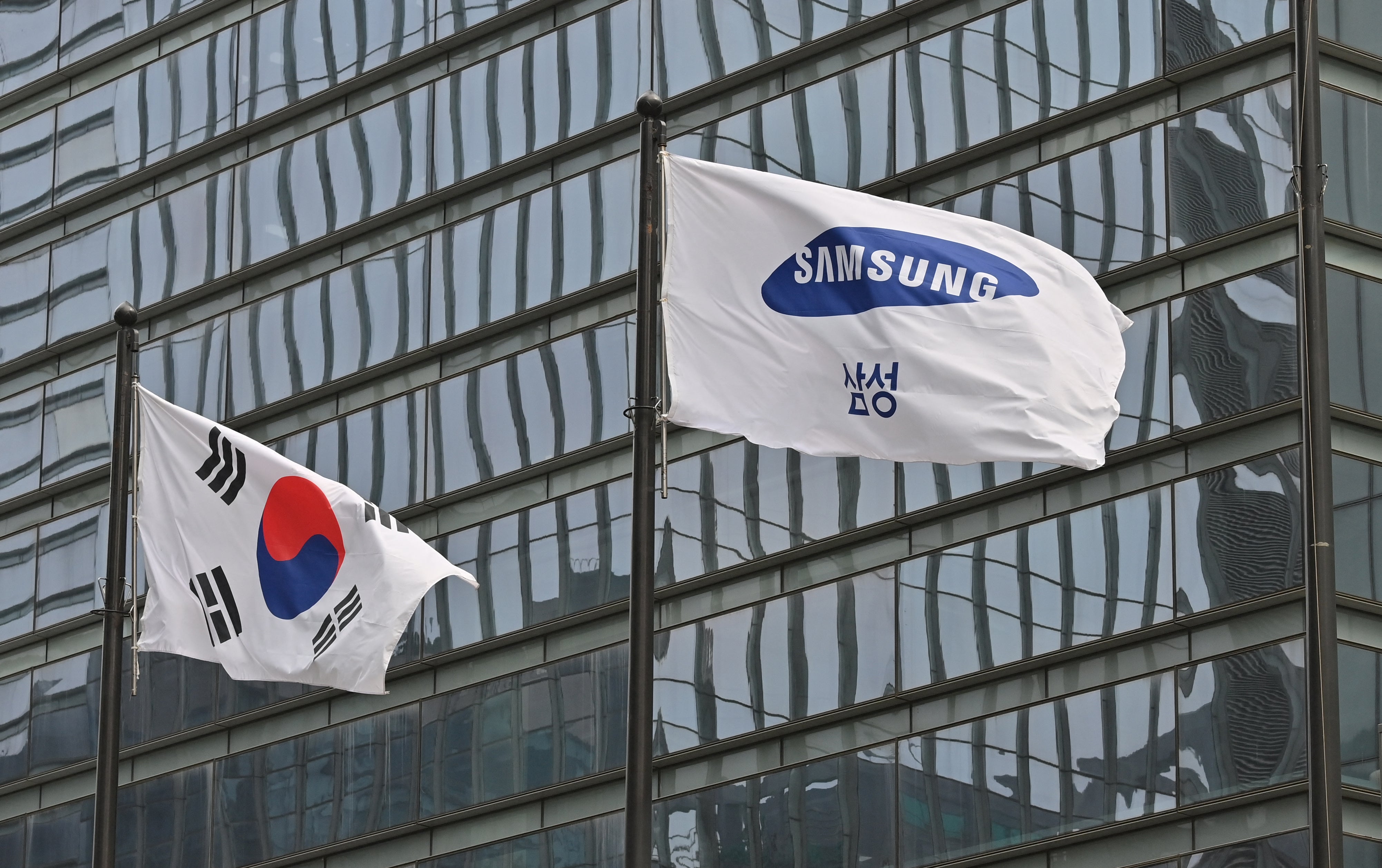 <p>File image: A Samsung flag and South Korean national flag flutter at the company’s Seocho building in Seoul</p>