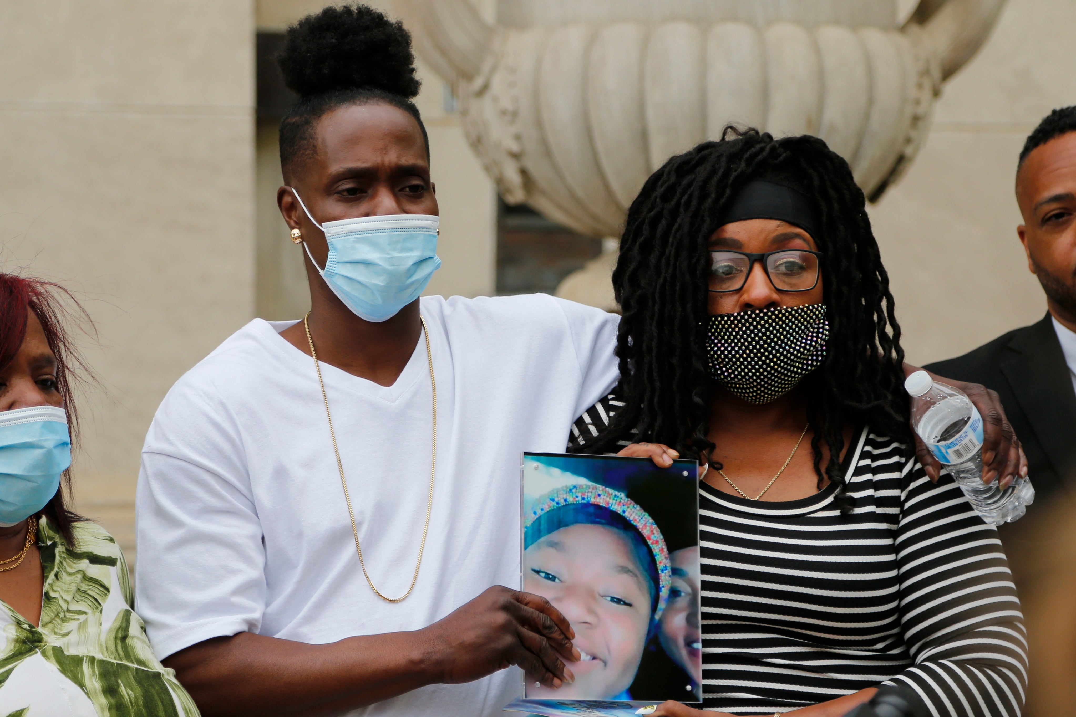 Myron Hammonds, left, and Paula Bryant, father and mother of Ma'Khia Bryant, the 16-year-old girl shot and killed by a Columbus police officer on April 20, hold a photo of their daughter during a news conference Wednesday, April 28, 2021, in Columbus, Ohio. Attorney Michelle Martin representing the family has called for full investigations into the teen’s fatal shooting by a Columbus police officer. (AP Photo/Jay LaPrete)