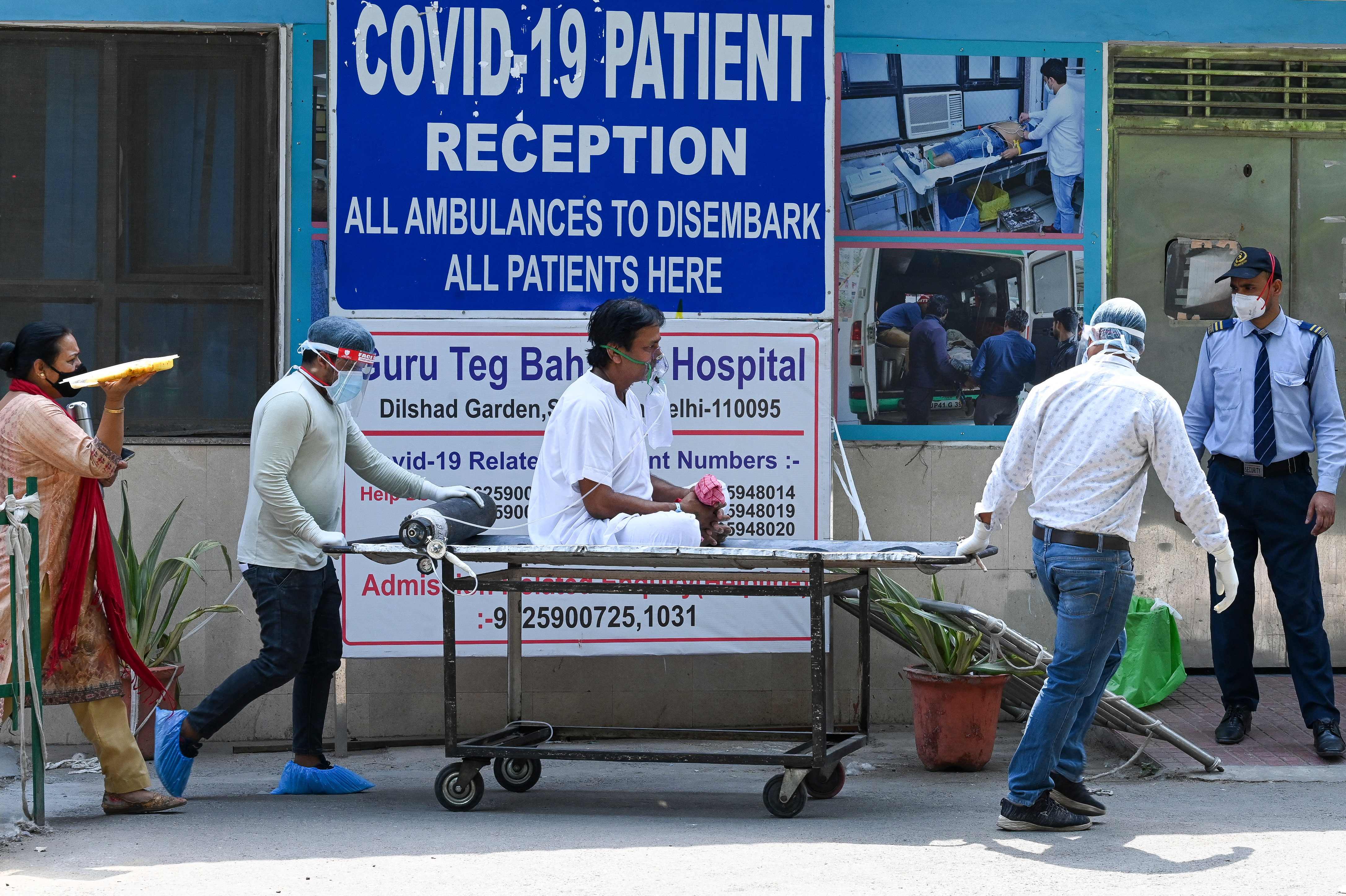 A patient is shifted to ward after admission at GTB hospital in New Delhi