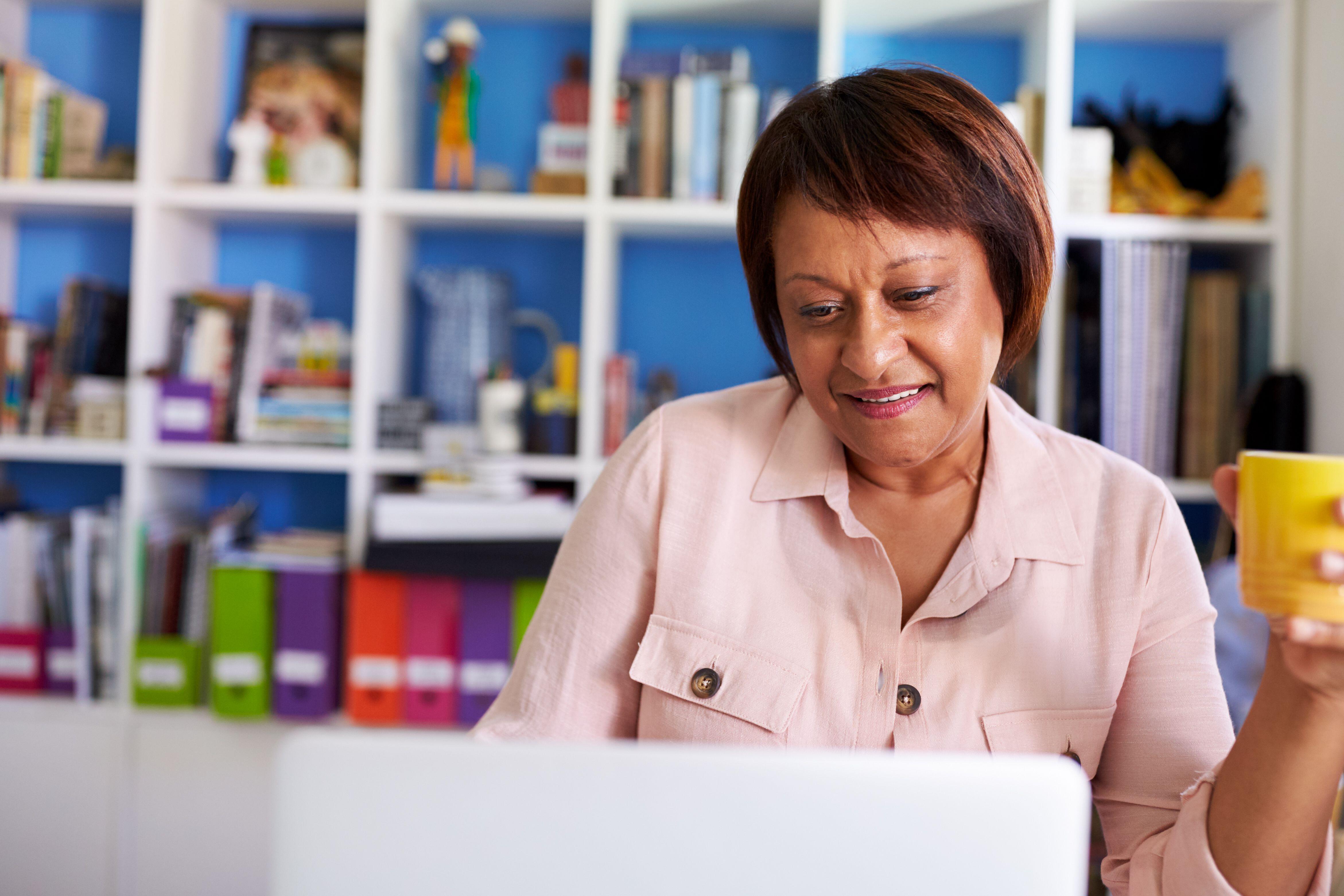 Mature woman looking at computer at home