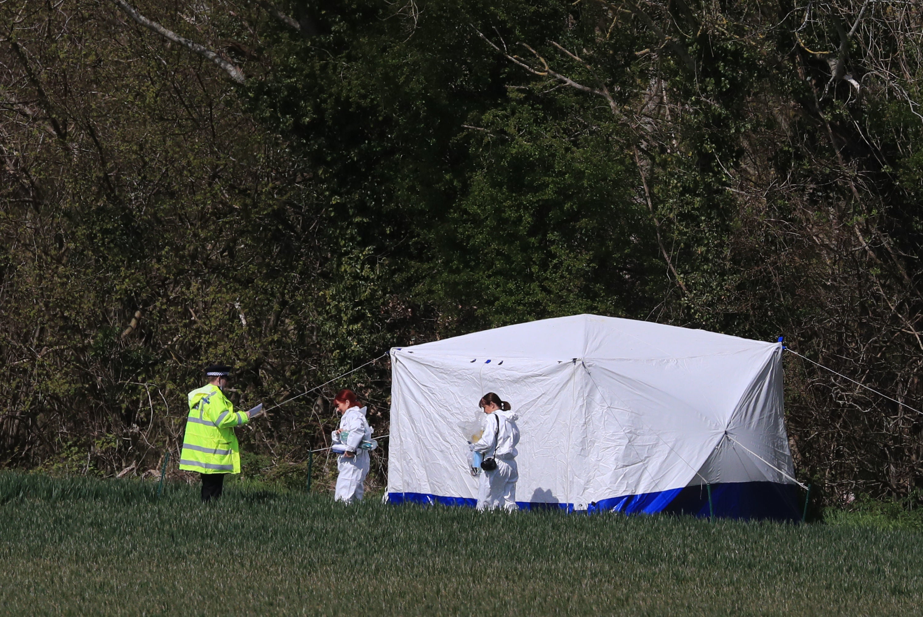 Police forensics investigators close to the scene in Snowdown where the body of Julia James was found