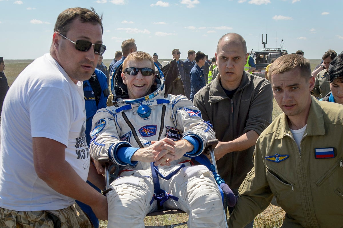 Tim Peake is carried to a medical tent after he, Tim Kopra of Nasa and and Yuri Malenchenko of Roscosmos landed in their Soyuz spacecraft in Kazakhstan in 2016