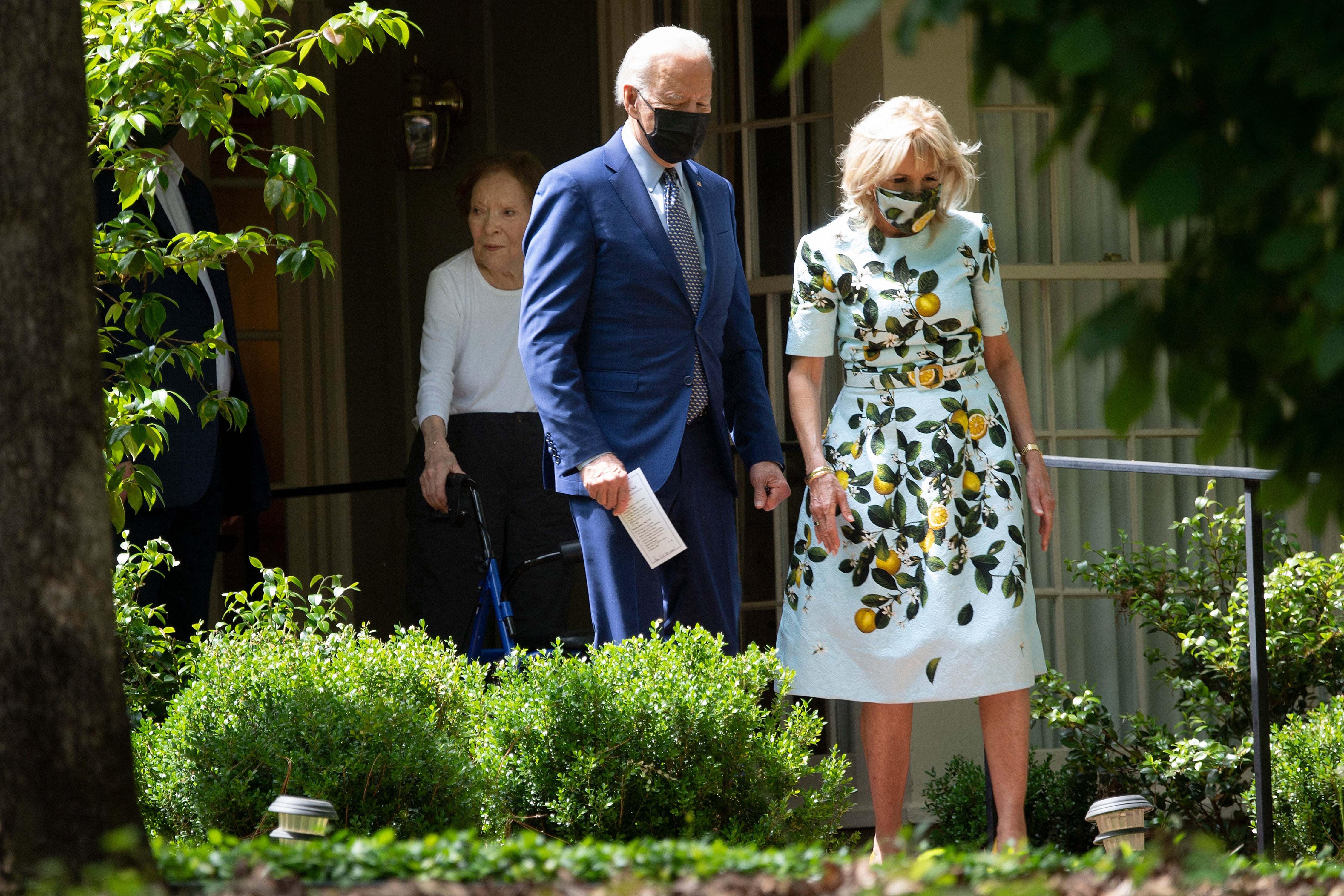 Former First Lady Rosalynn Carter (L) walks US President Joe Biden and US first lady Dr. Jill Biden out after they after visited former US President Jimmy Carter, April 29, 2021, in Plains, Georgia