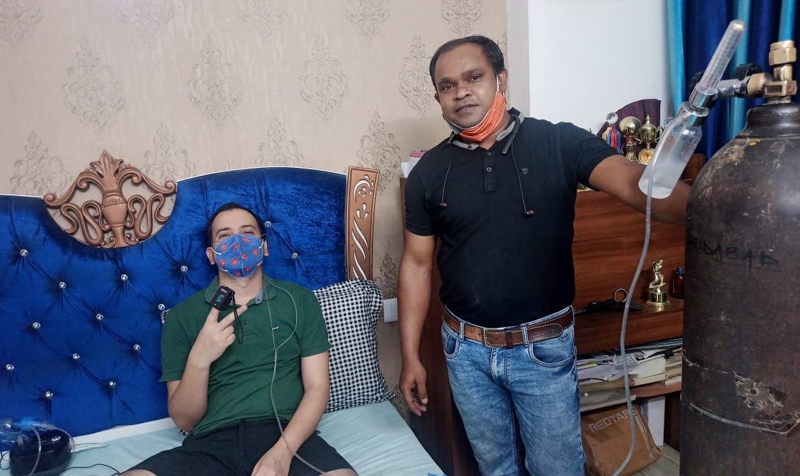 Devendra Kumar Rai (black t-shirt) brought an oxygen cylinder from over 1,400 kilometres away for his childhood friend Rajan Kumar Singh (green t-shirt) who is suffering from coronavirus infection