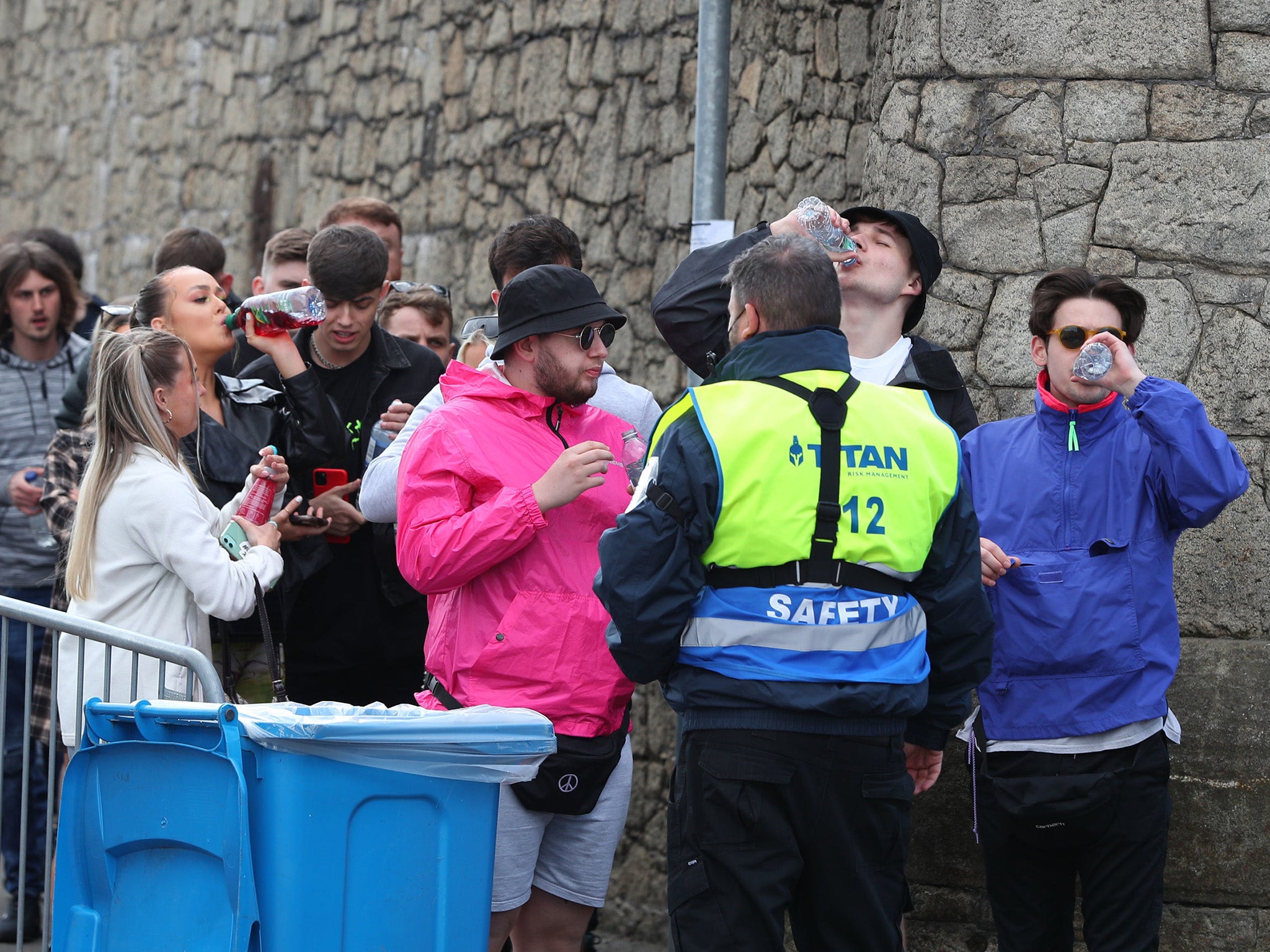 Partygoers take a sip before entry