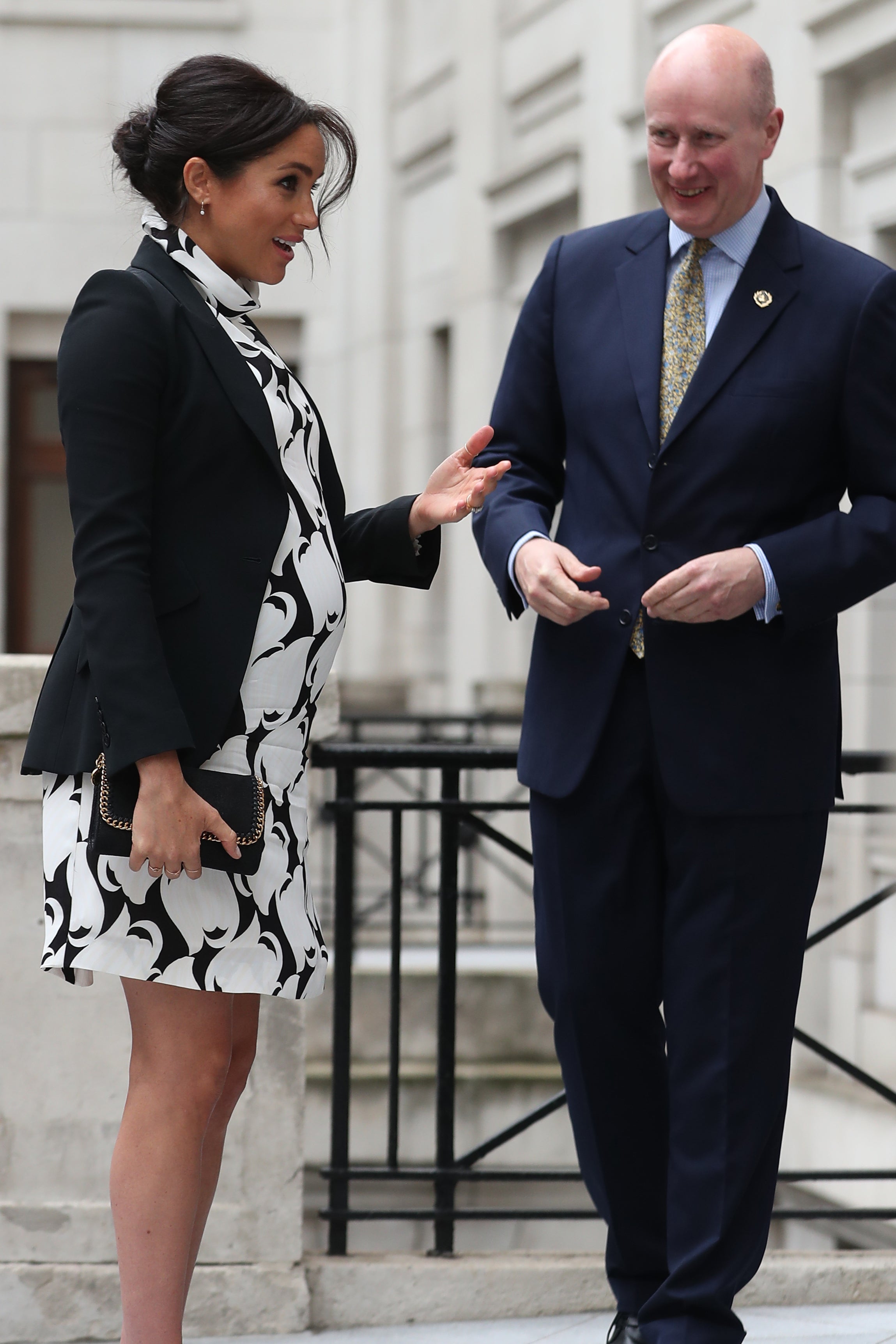 The Duchess of Sussex is greeted by Lord Geidt ahead of an International Women’s Day event in March 2019