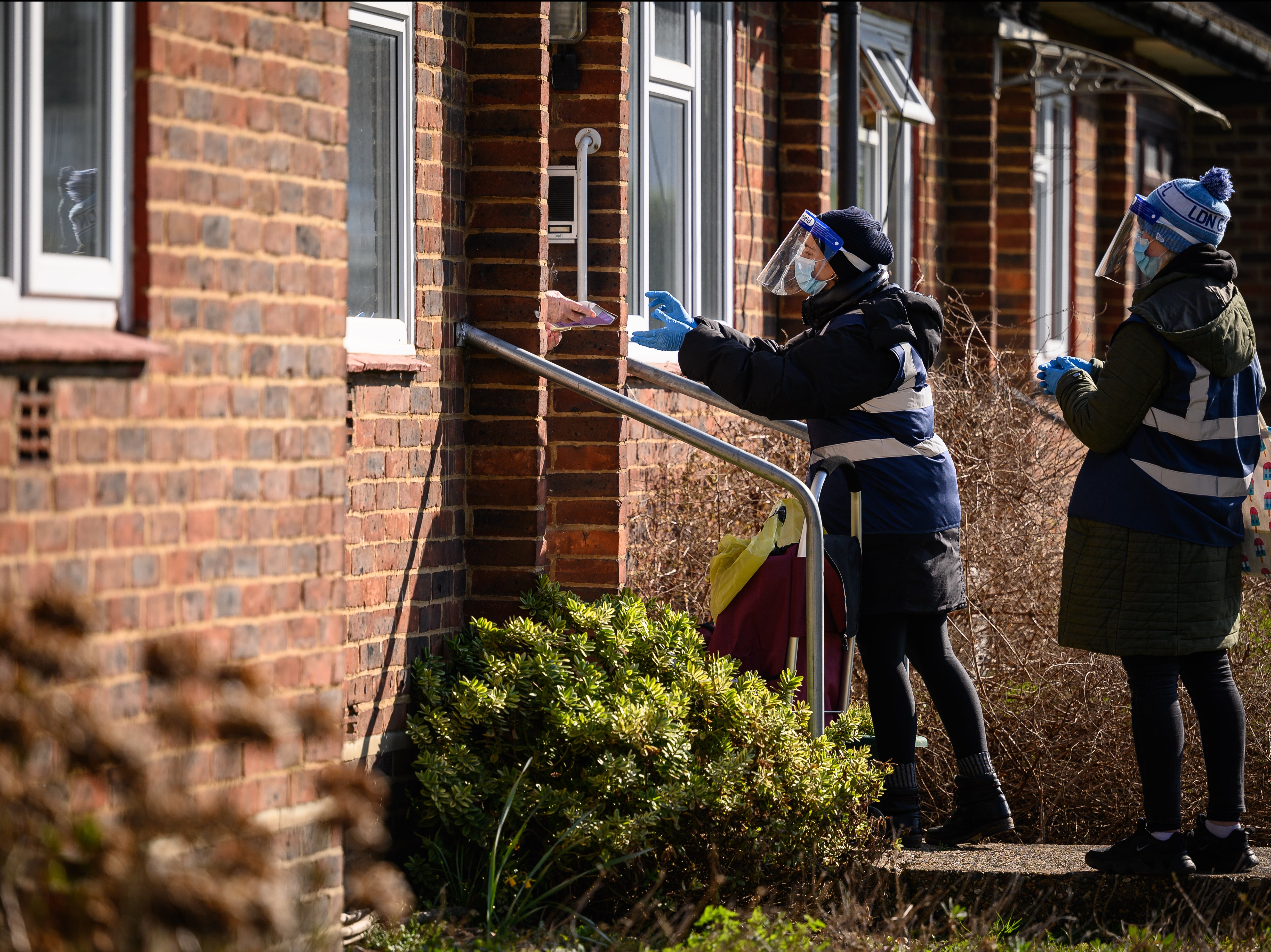 Volunteers collect Covid-19 test kits from residents in a targeted postcode near Muswell Hill on 22 March