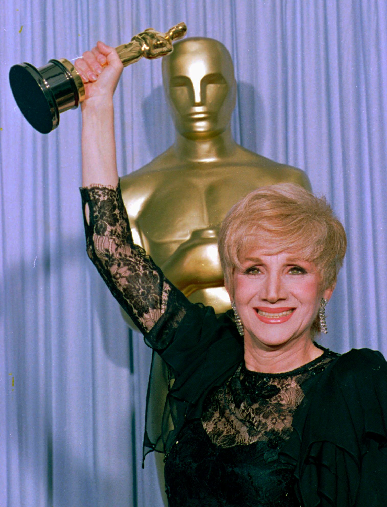 Olympia Dukakis, who died on Satuday aged 89, holds her Oscar for Moonstruck awarded in 1988.