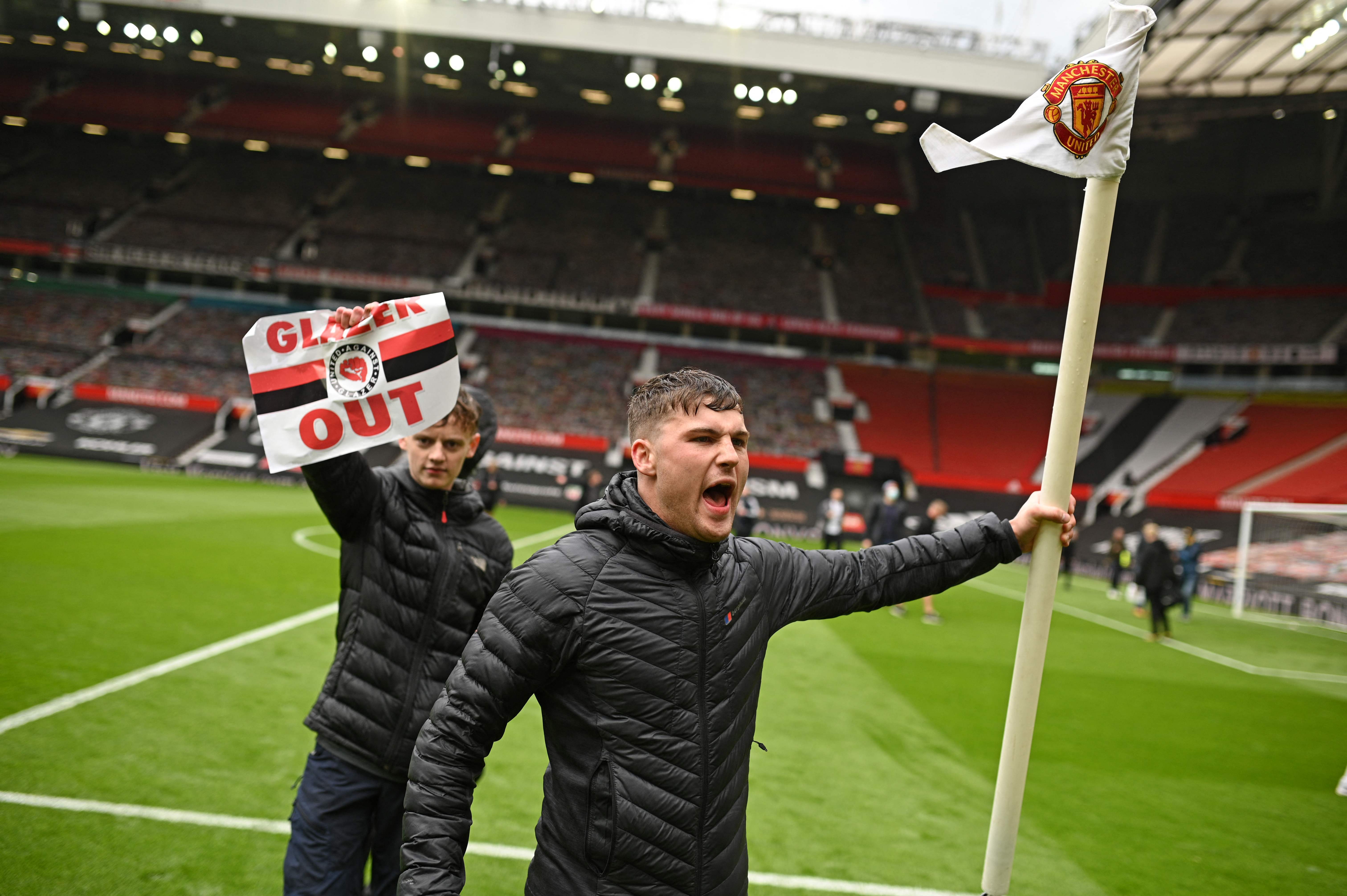 United supporters on the Old Trafford pitch