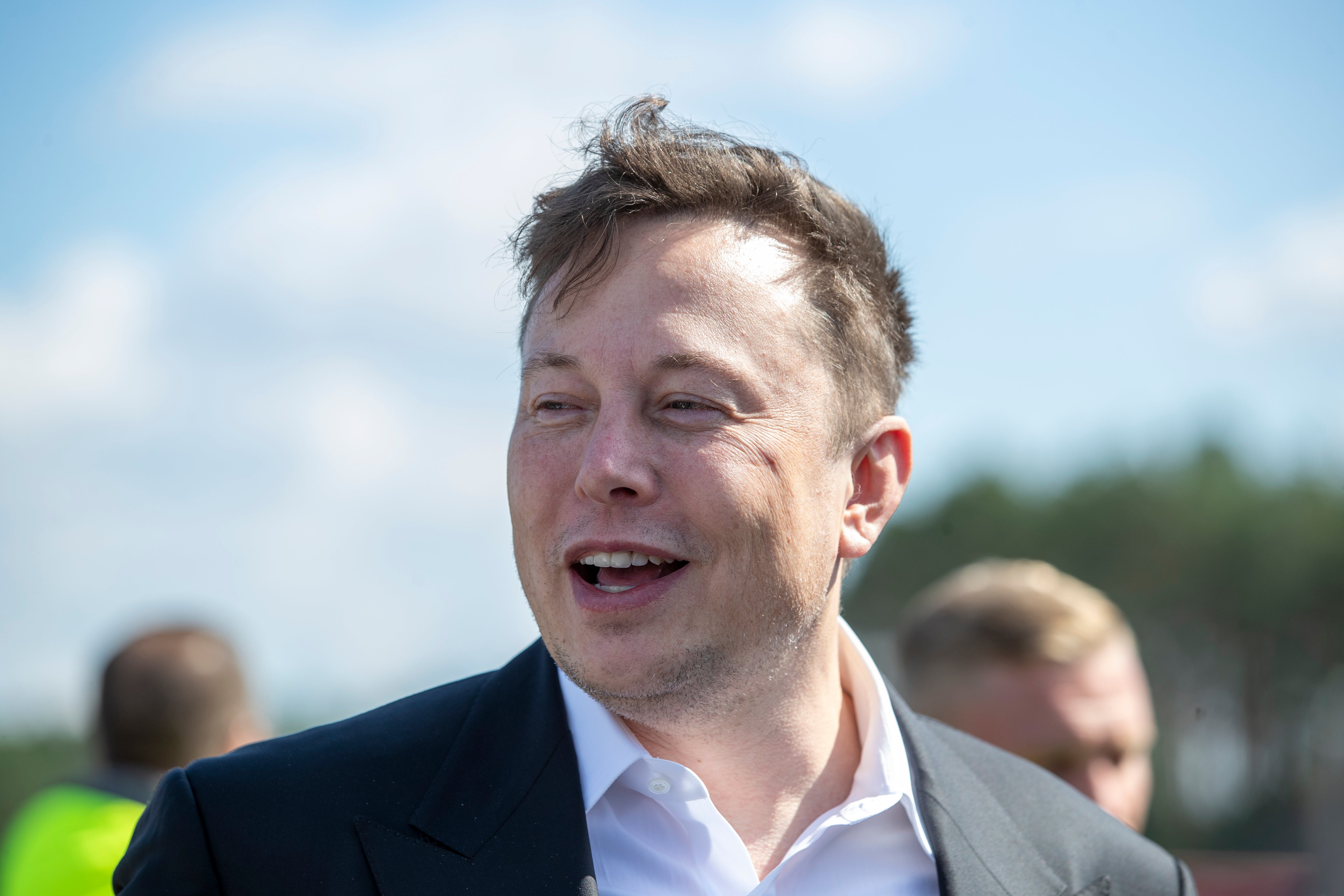 Tesla head Elon Musk talks to the press as he arrives to to have a look at the construction site of the new Tesla Gigafactory near Berlin