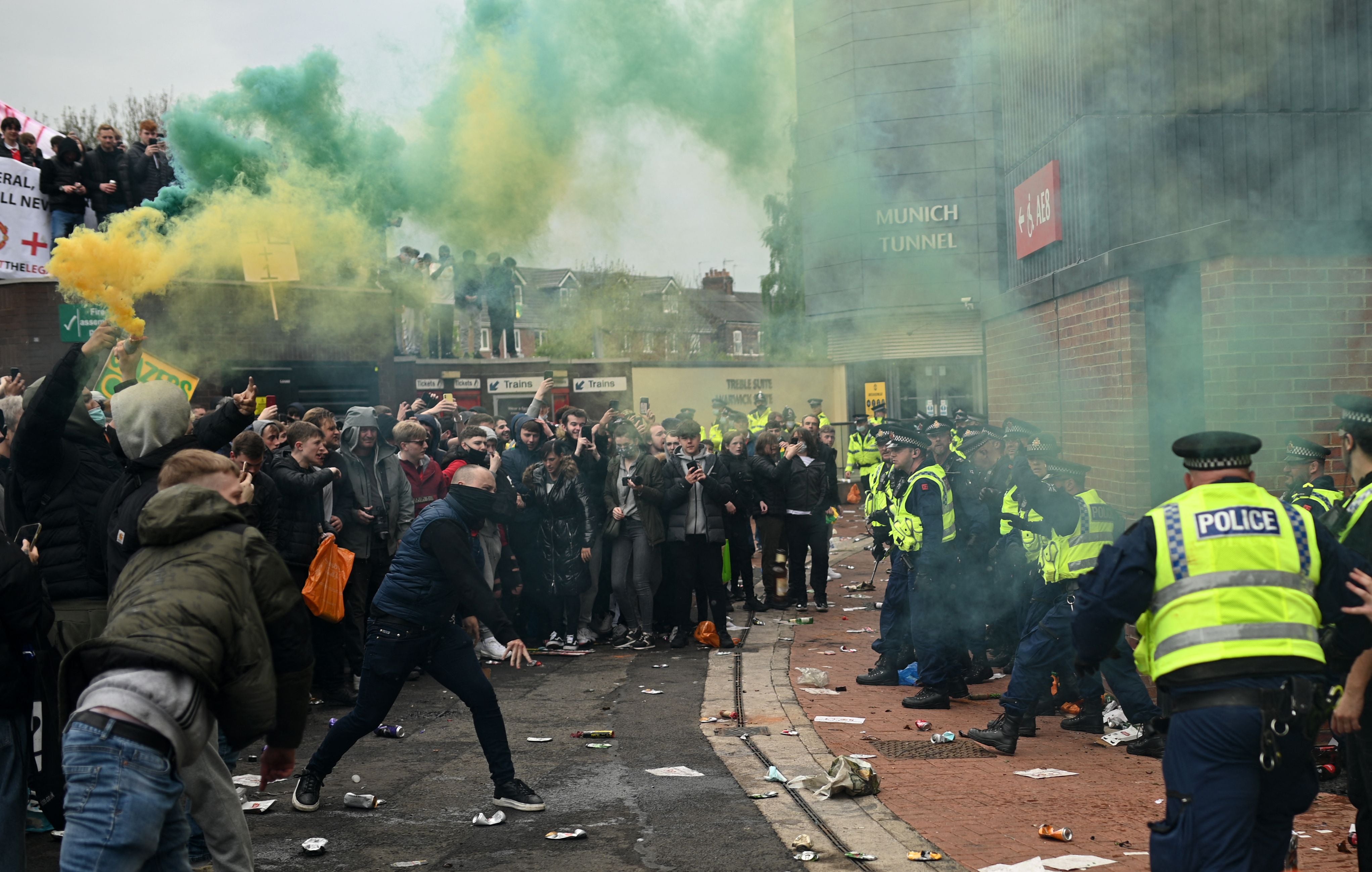 Police try to move people away from the stadium after a supporter's protest against Manchester United's owners