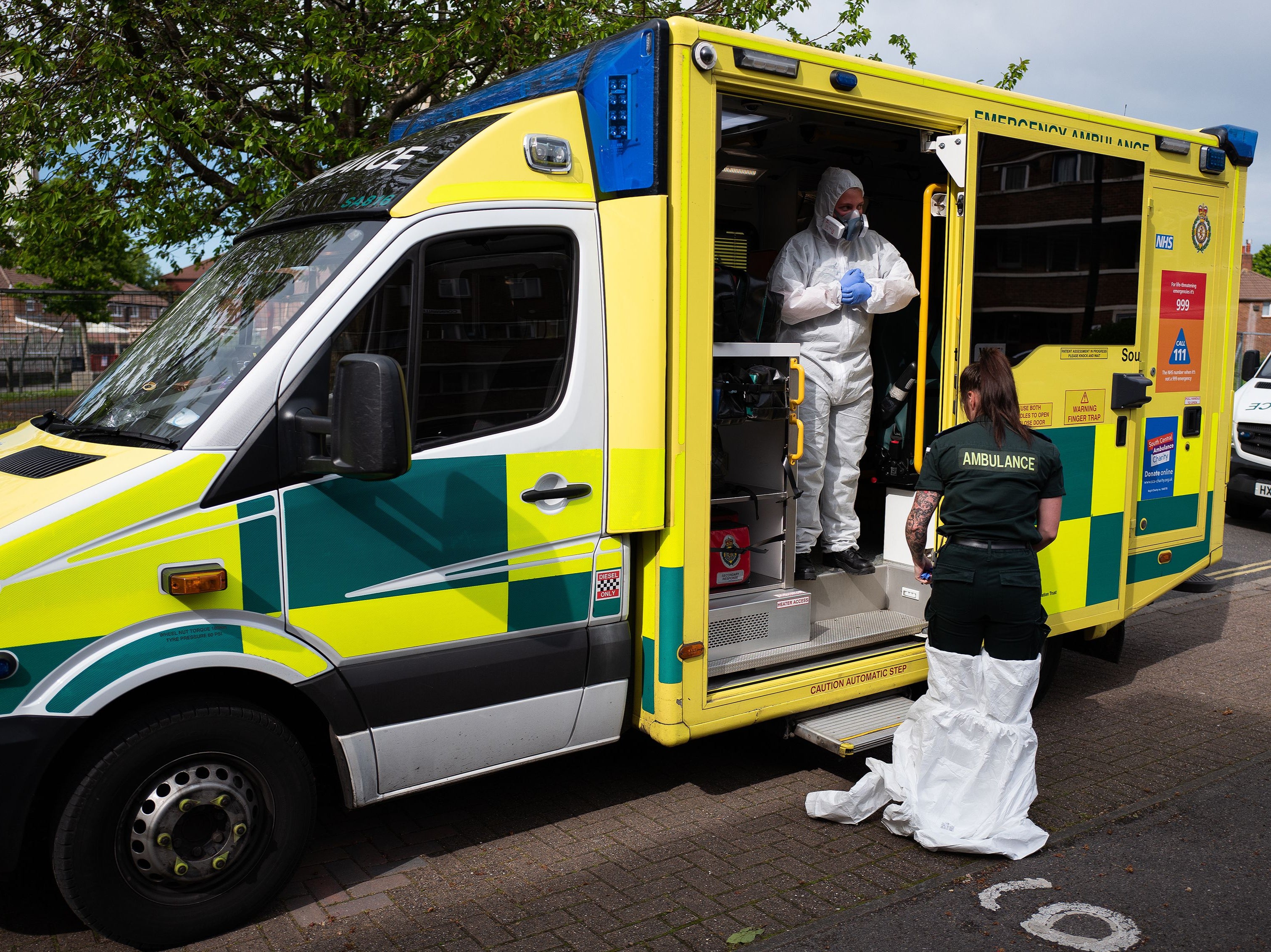 An ambulance crew remove their PPE after responding to a false alarm call for a heart attack in Portsmouth