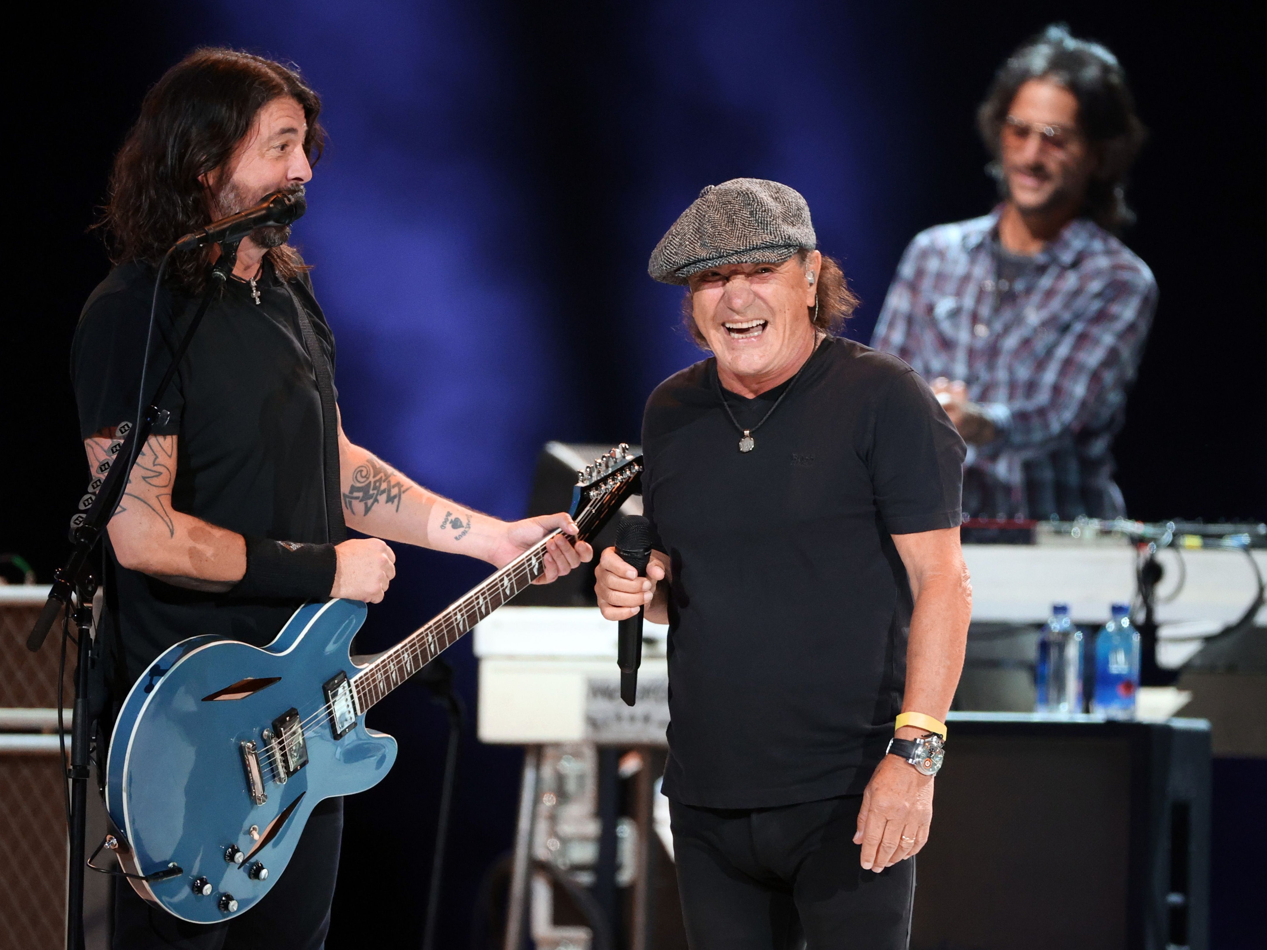 Dave Grohl and Brian Johnson perform together during Vax Live