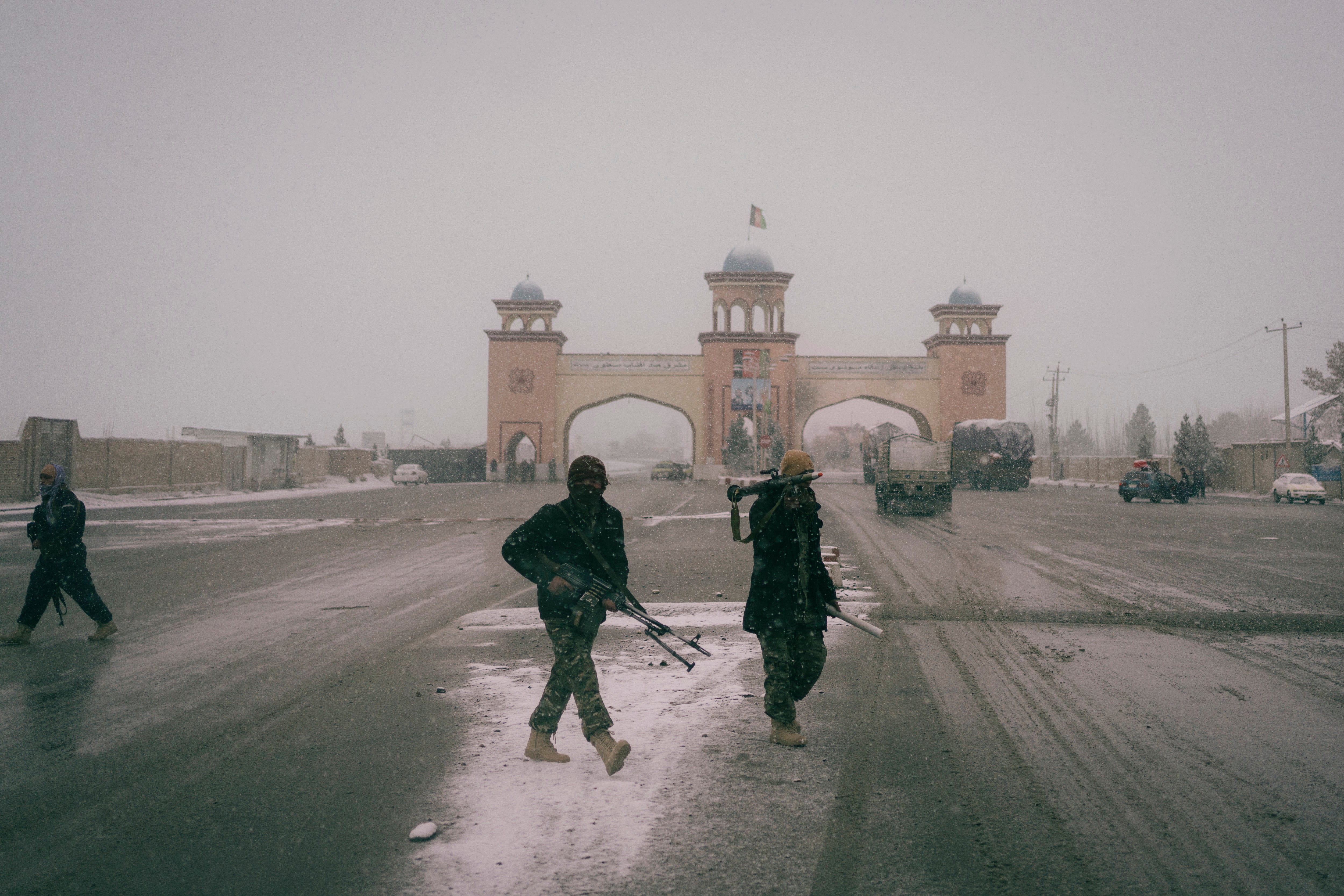 Government soldiers take position against a Taliban attack near the outer gate of Mazar-e Sharif in December