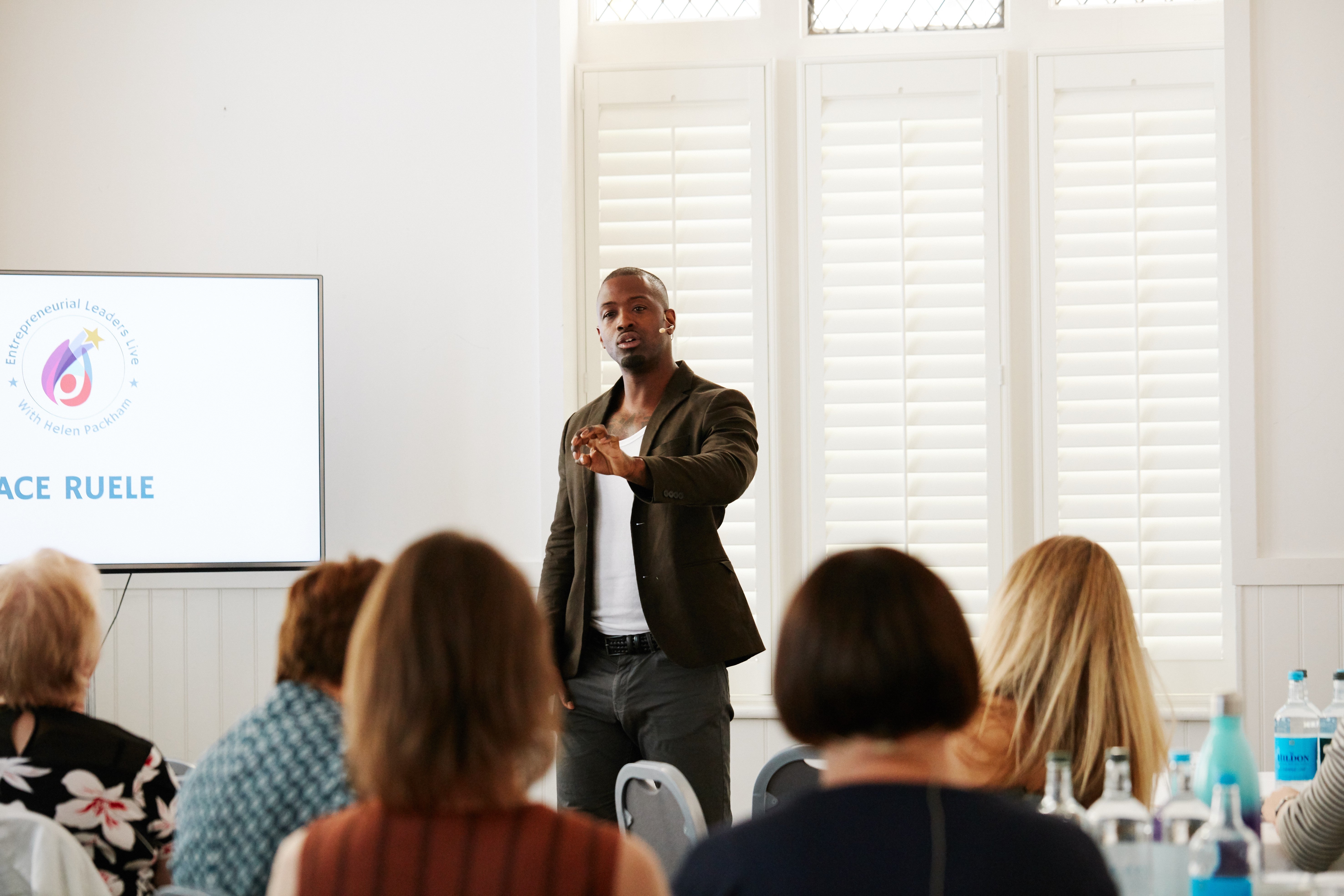 Ace delivering a presentation to young people.