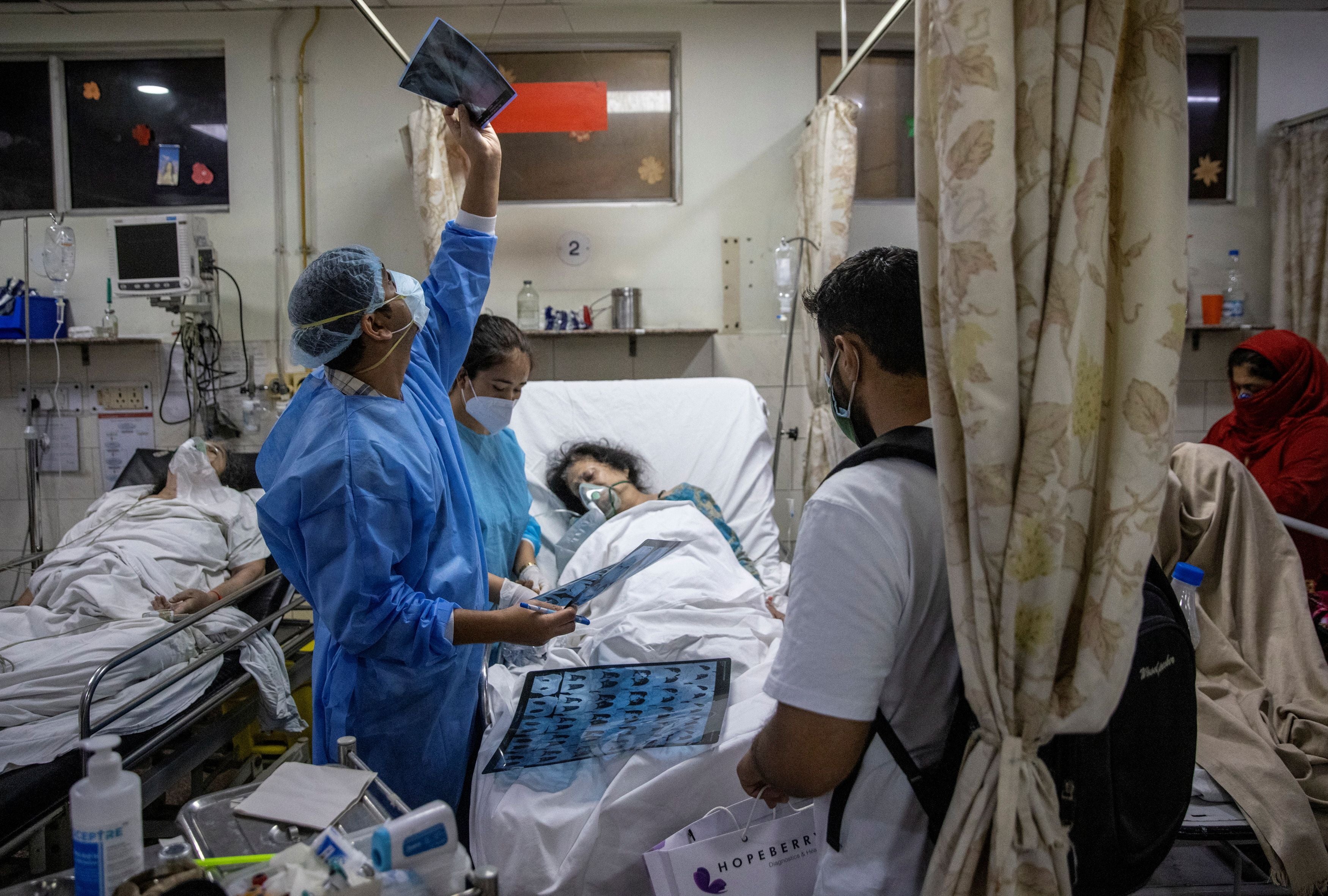 Rohan Aggarwal, 26, a resident doctor treating patients suffering from the coronavirus disease (COVID-19), looks at a patient’s x-ray scan, inside the emergency room of Holy Family Hospital, during his 27-hour shift in New Delhi, India, May 1, 2021.