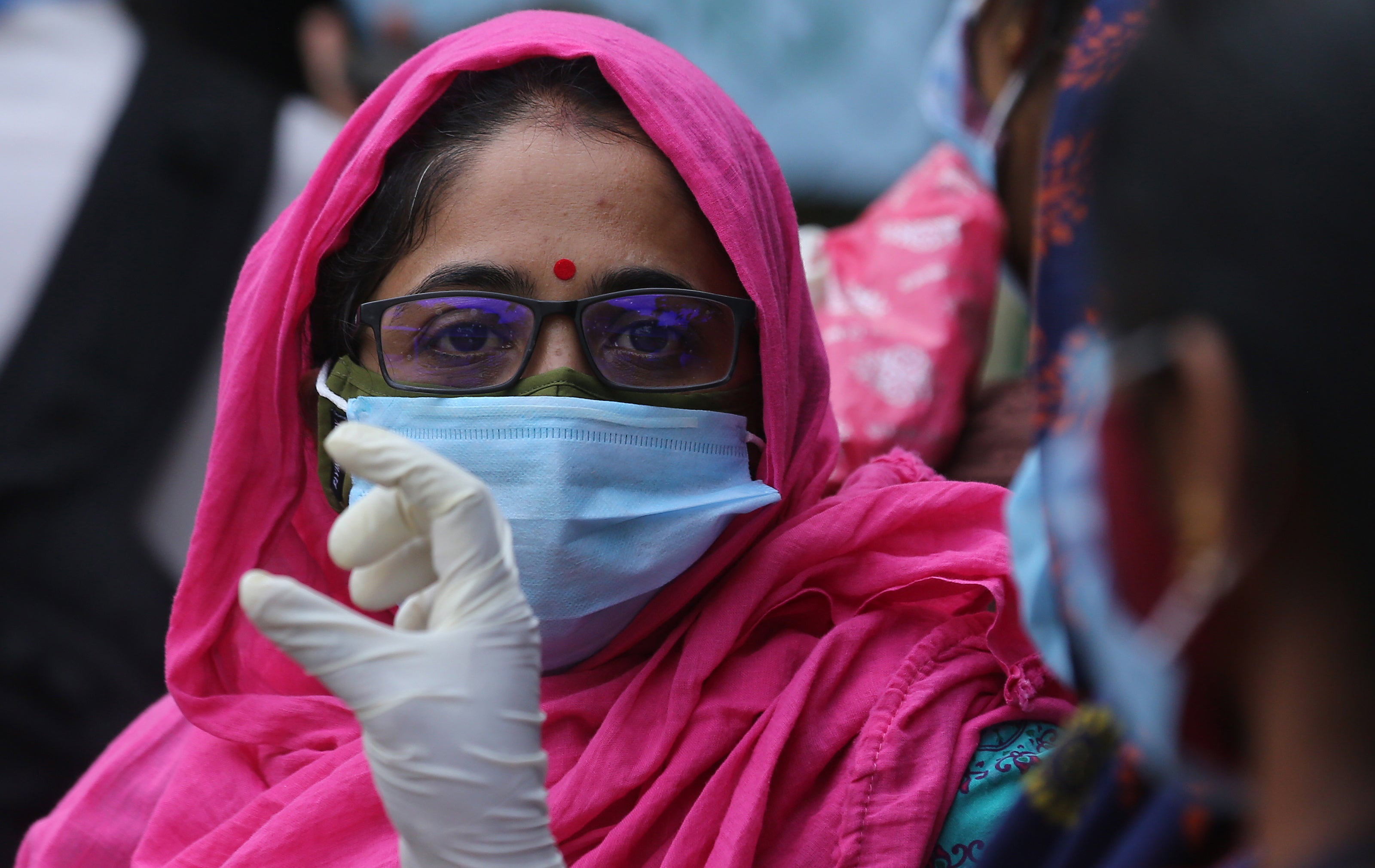 An Indian woman waits to get her COVID-19 vaccine during a vaccination campaign at KC General Hospital in Bangalore