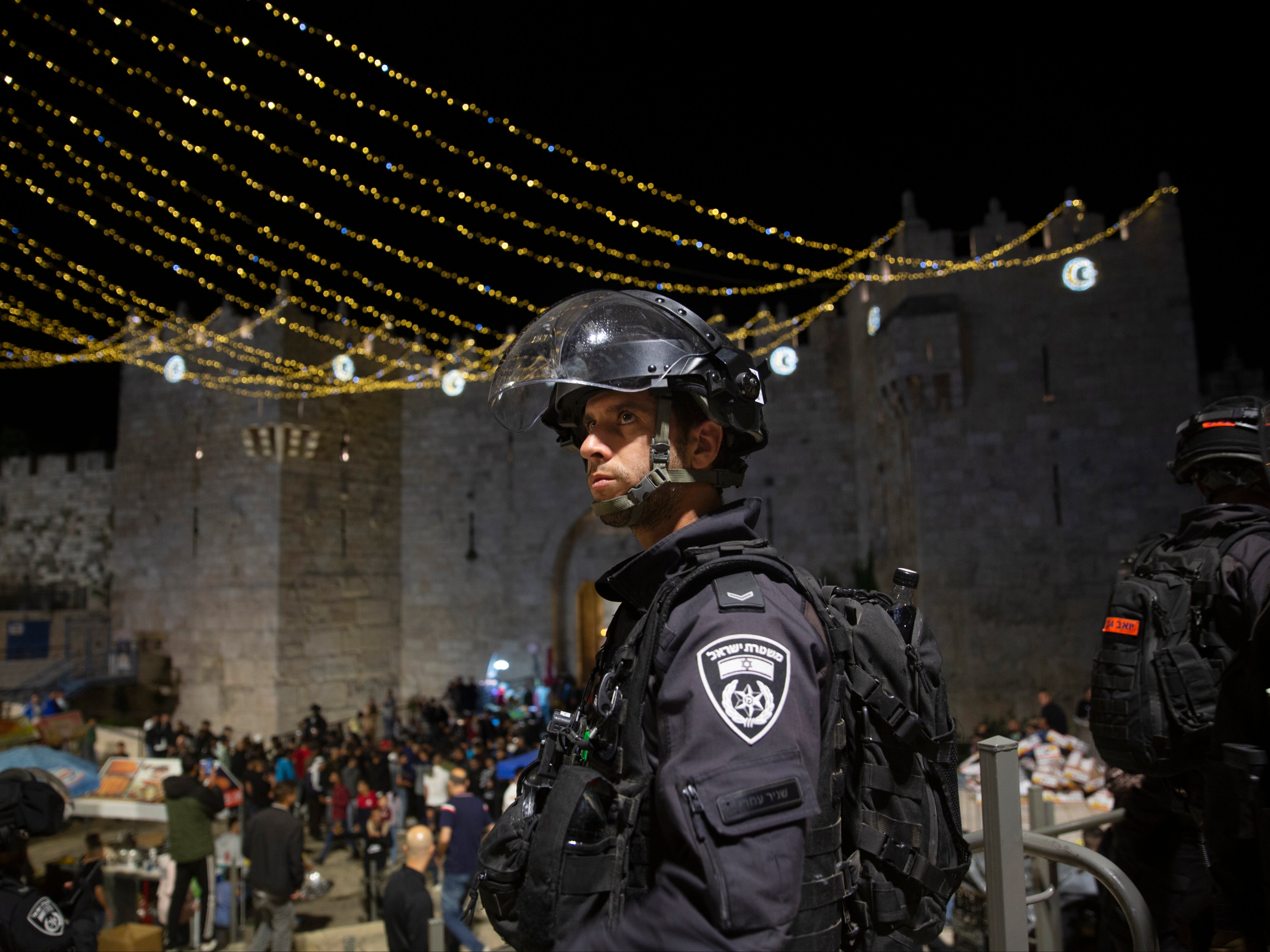 An Israeli police officer stands guard at the Damascus Gate to the Old City of Jerusalem after clashes at the Al-Aqsa Mosque compound