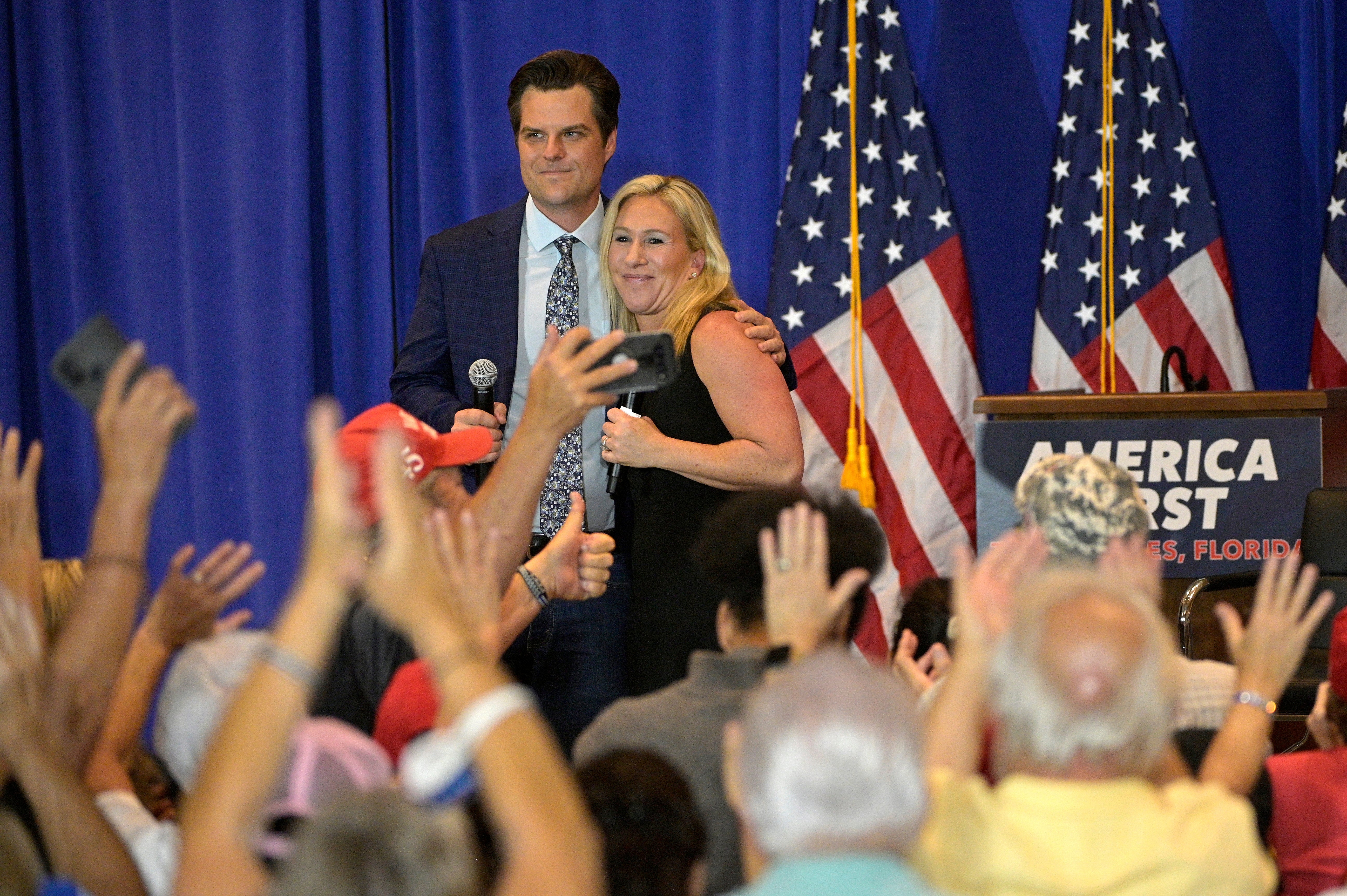 Republican representatives Matt Gaetz and Marjorie Taylor Greene hug after an ‘America First' rally in Florida