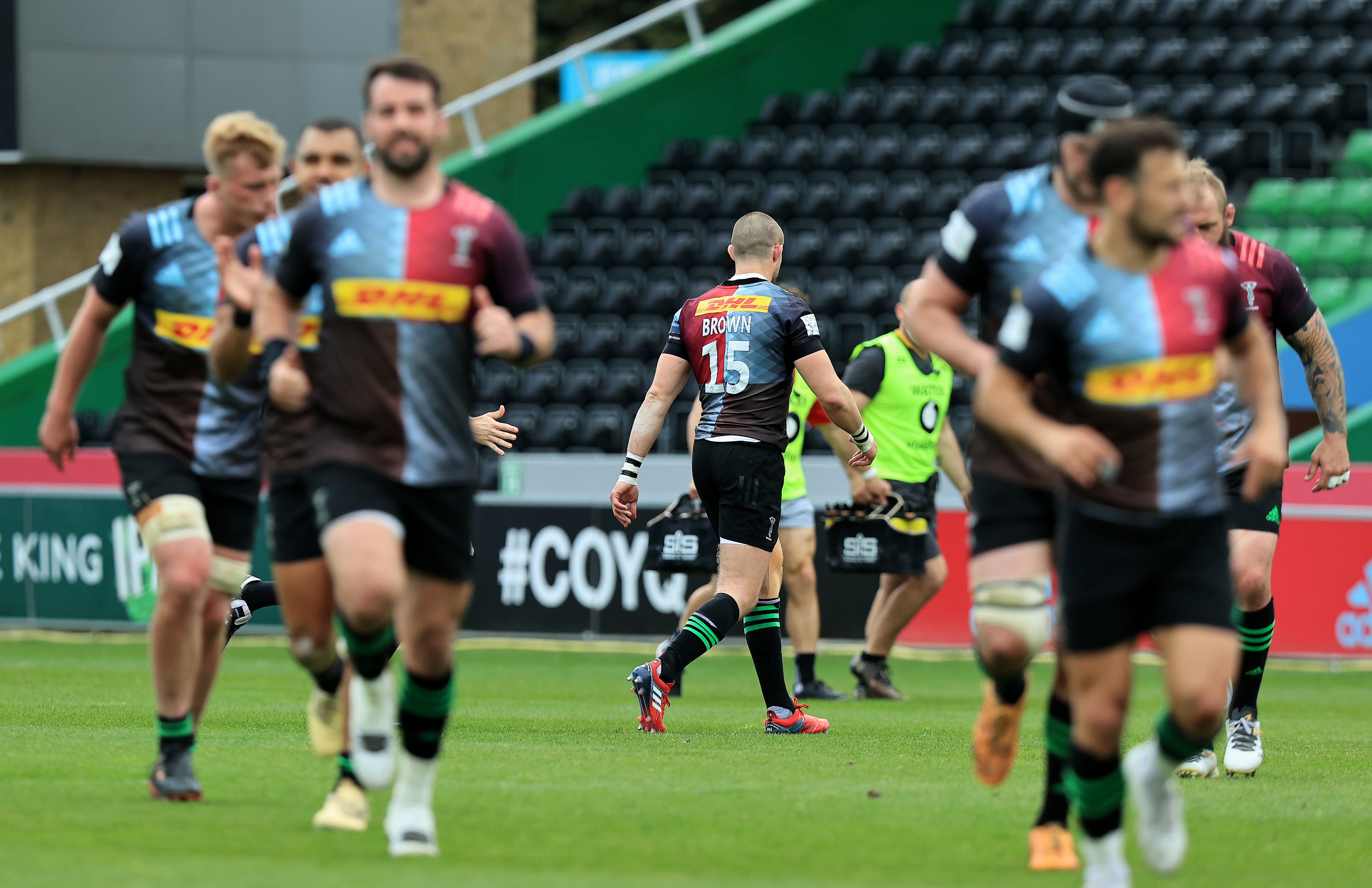 Mike Brown walks off the pitch after being sent off by referee Wayne Barnes