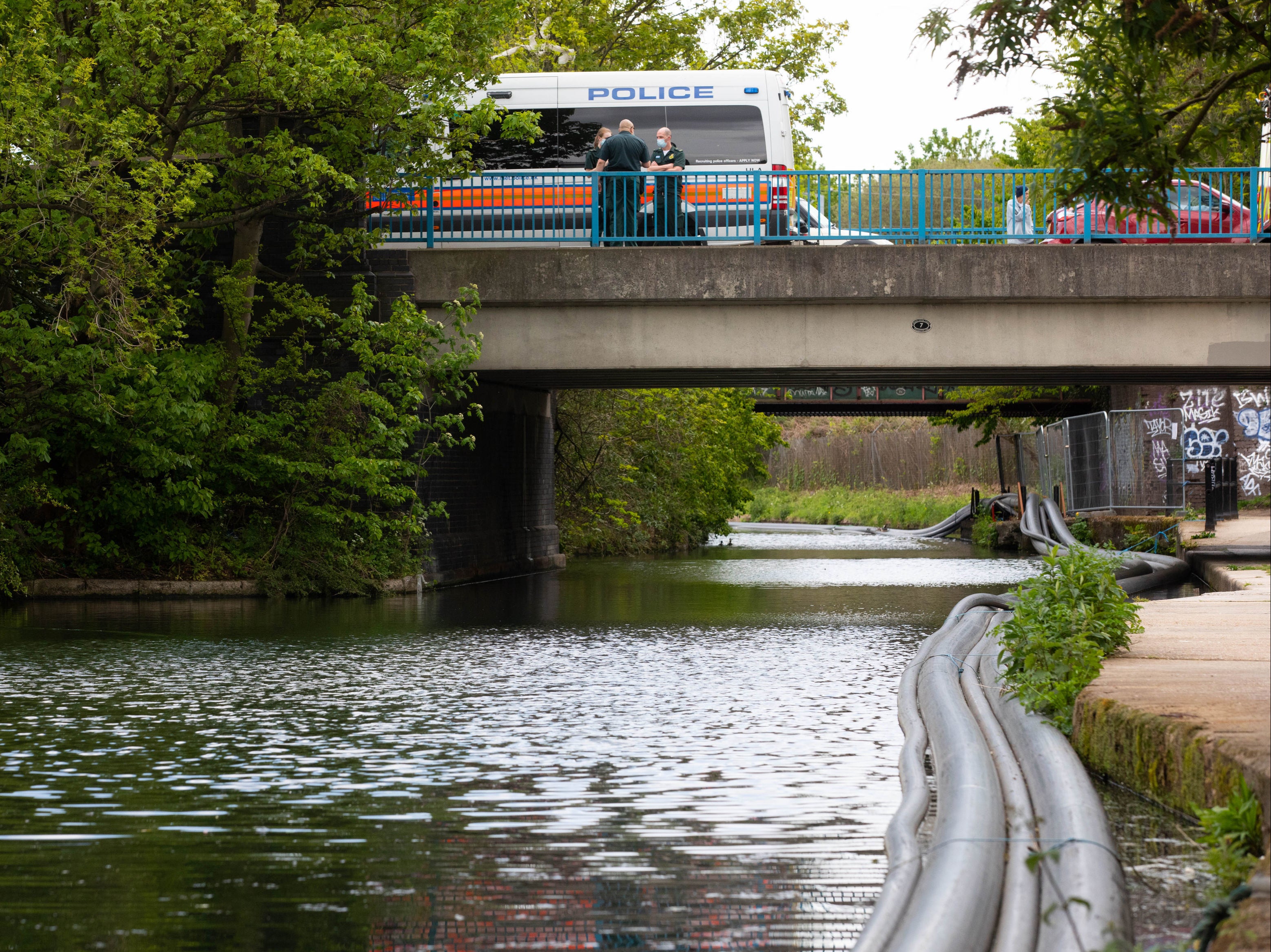 Police officers on scene at the Grand Union Canal near Old Oak Lane in northwest London.