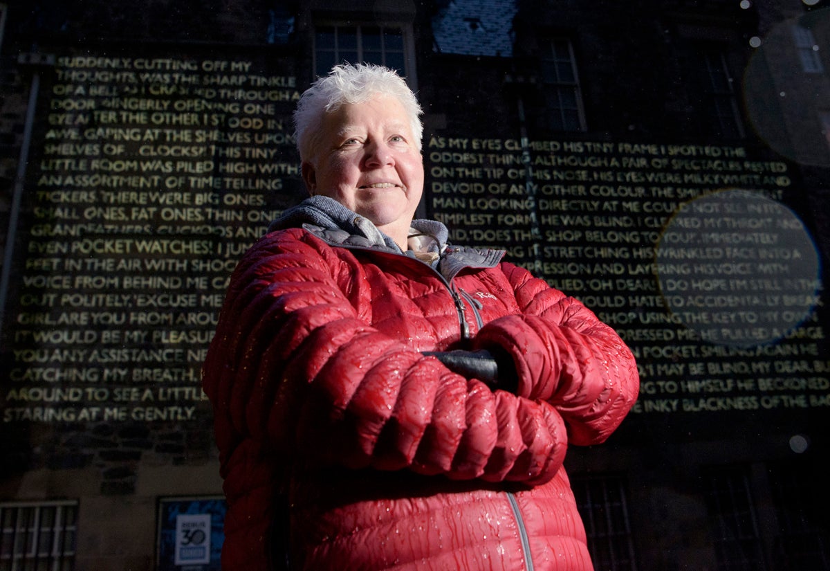 The crime writer Val McDermid in front of words and images from her book ‘New Year Resurrection’