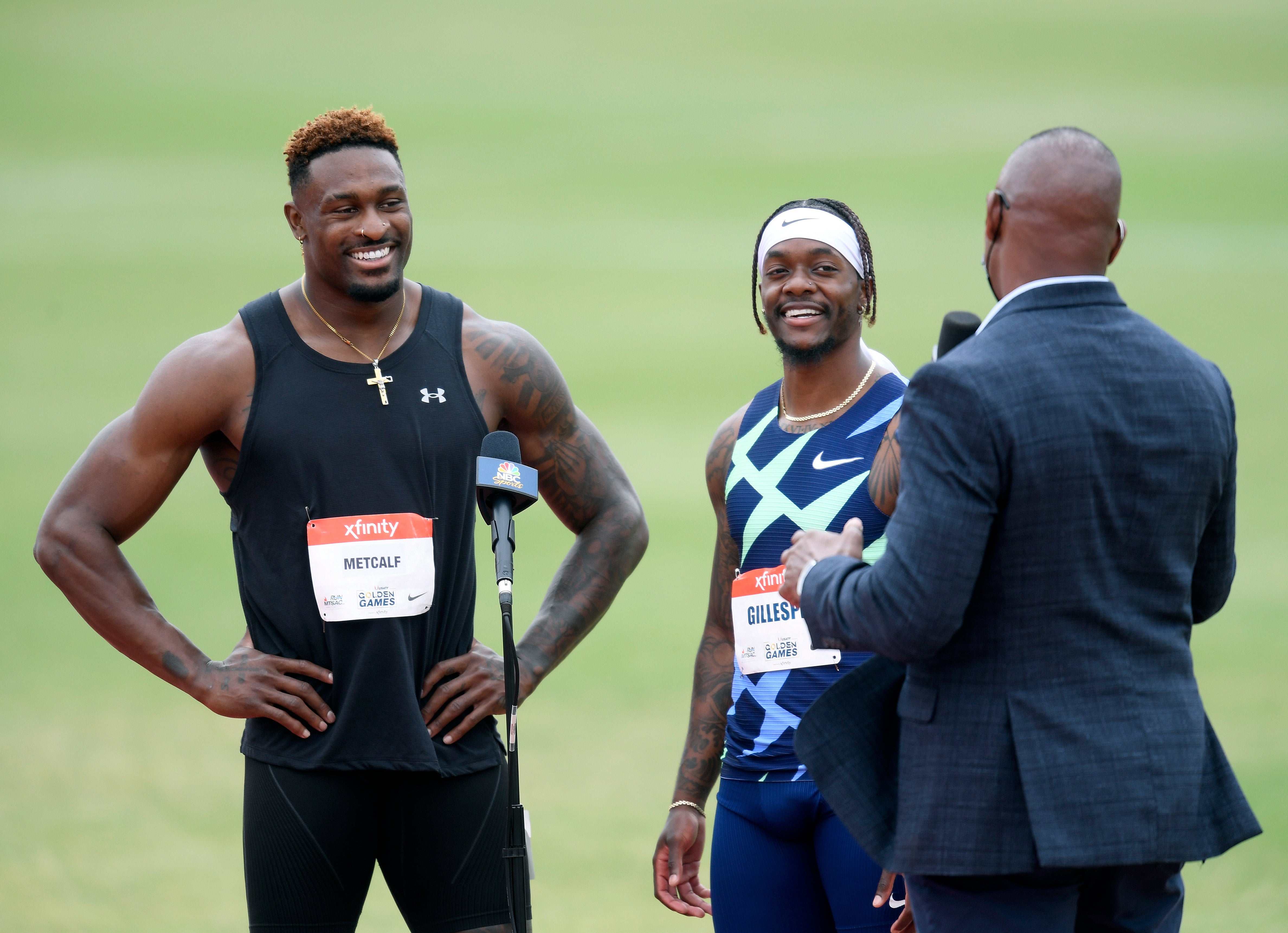 DK Metcalf and Cravon Gillespie laugh after their race in the Men 100 Meter Dash