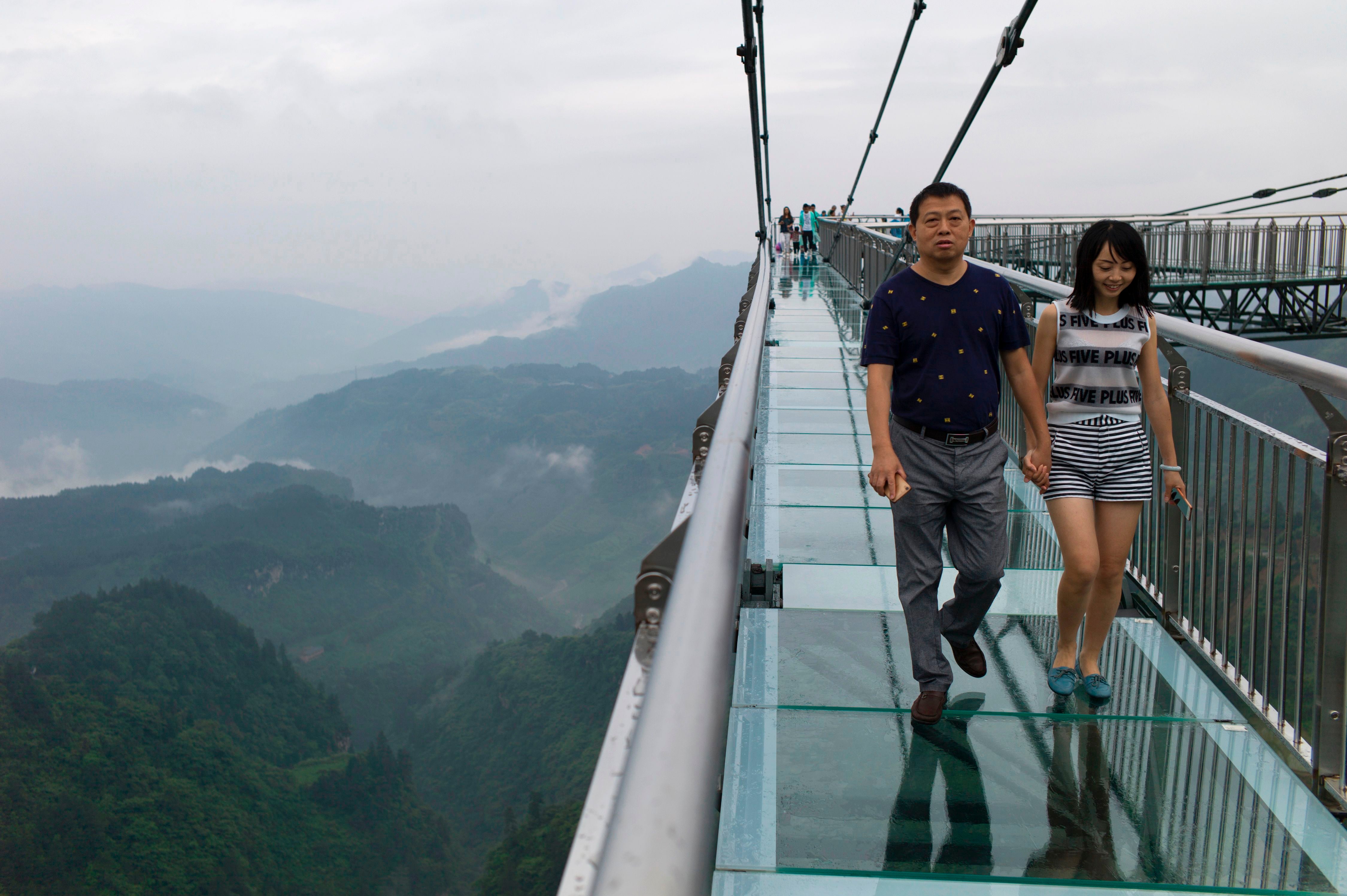 File A glass-bottomed skywalk, certified as the world’s longest, at the Ordovician park in Wansheng. Hovering more than 100 metres (328 feet) above a gaping chasm