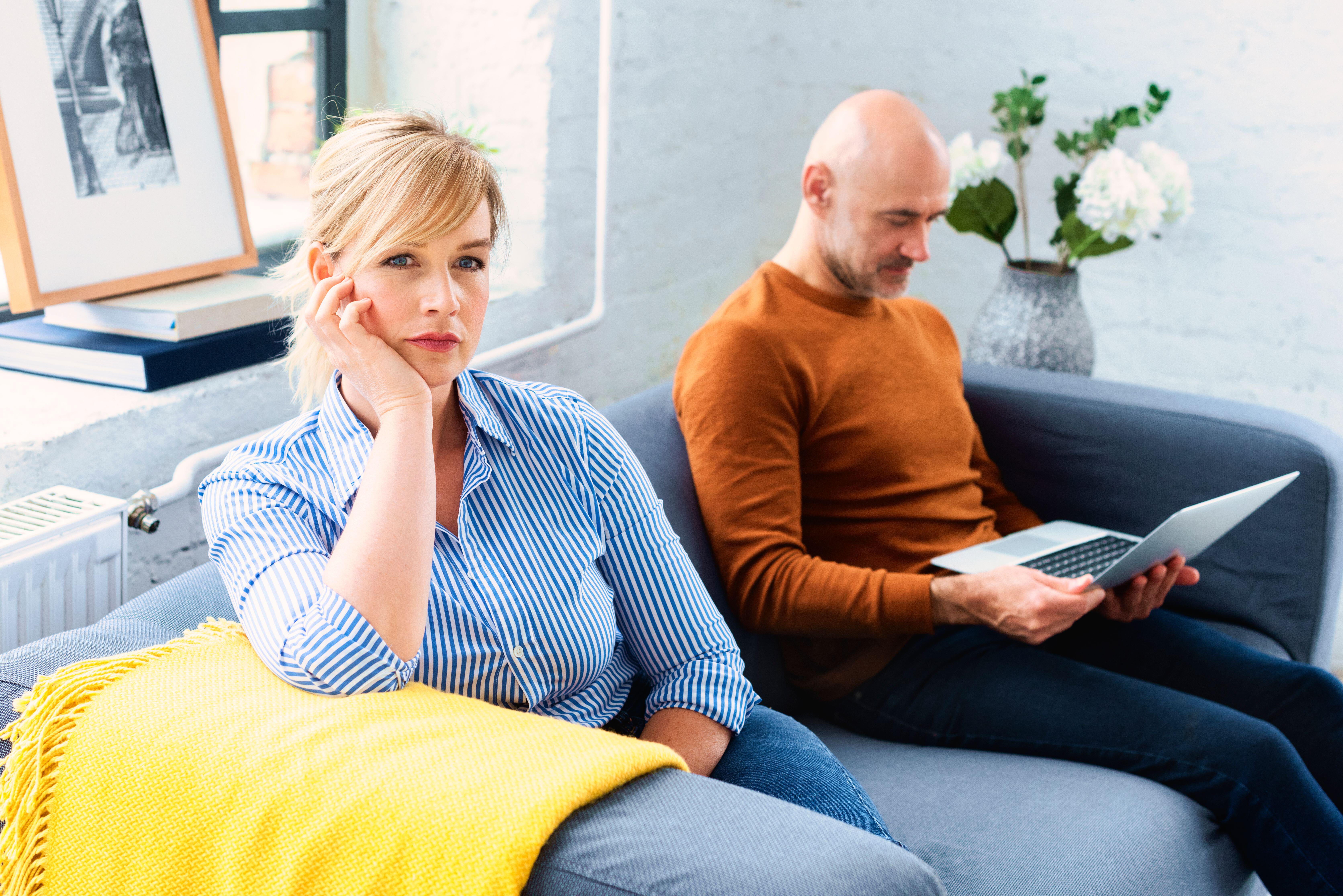 Middle-aged couple looking distant