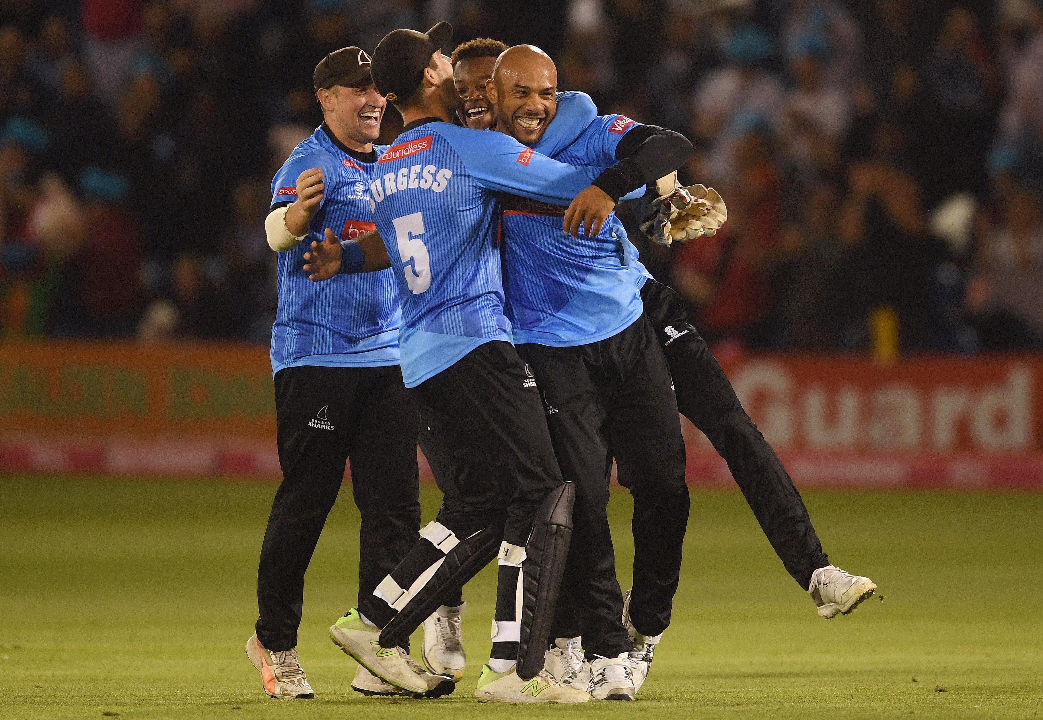 Mills, known for his pace while bowling, celebrates with team-mates