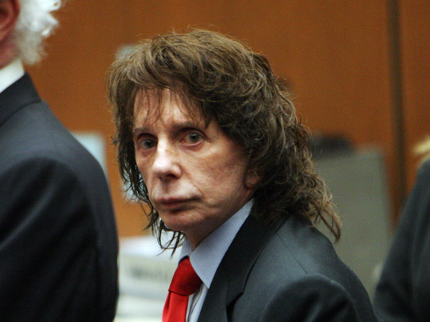 Phil Spector flanked by lawyers at his murder trial in 2009