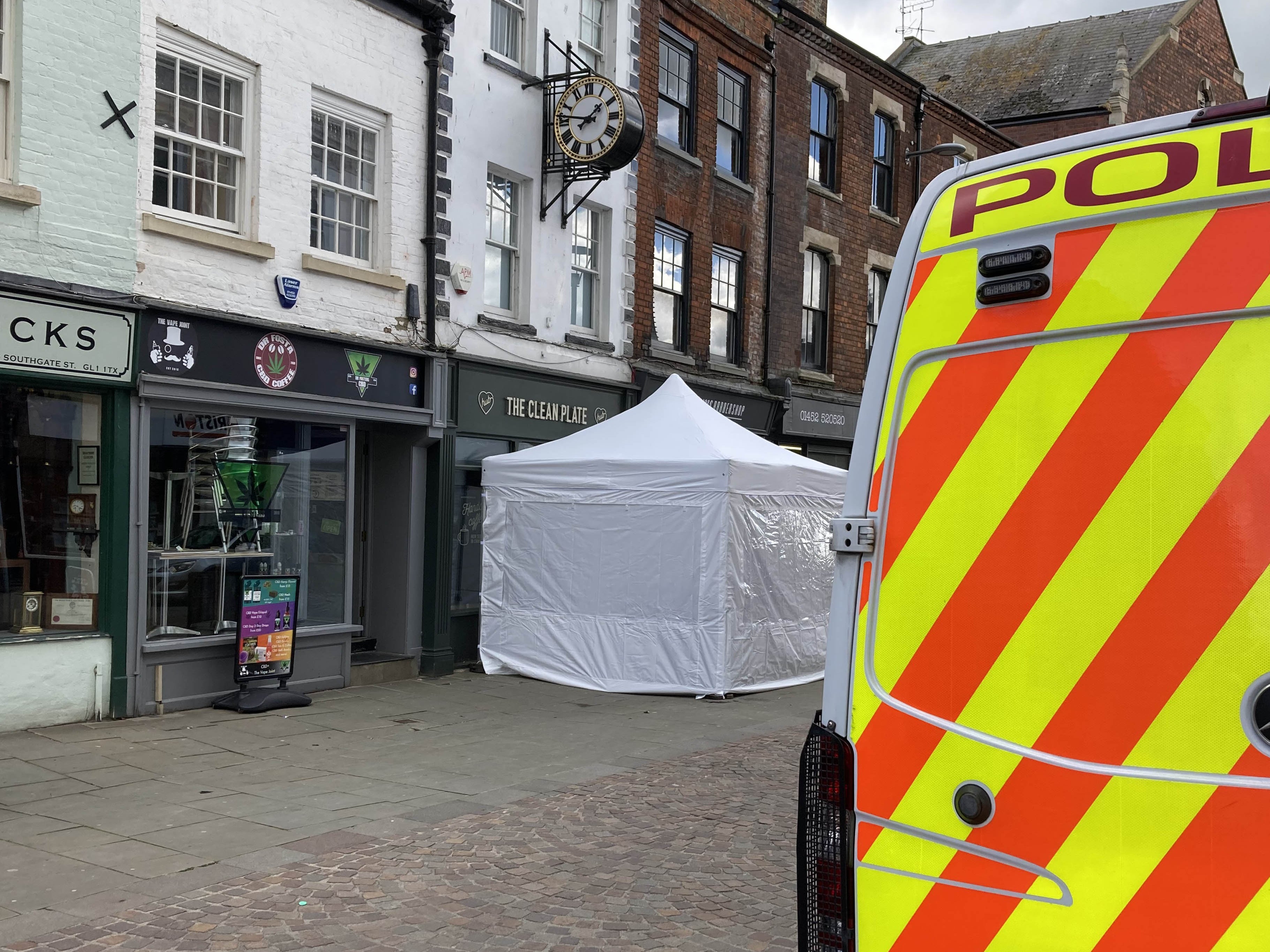 A police tent outside The Clean Plate cafe in Southgate Street, Gloucester