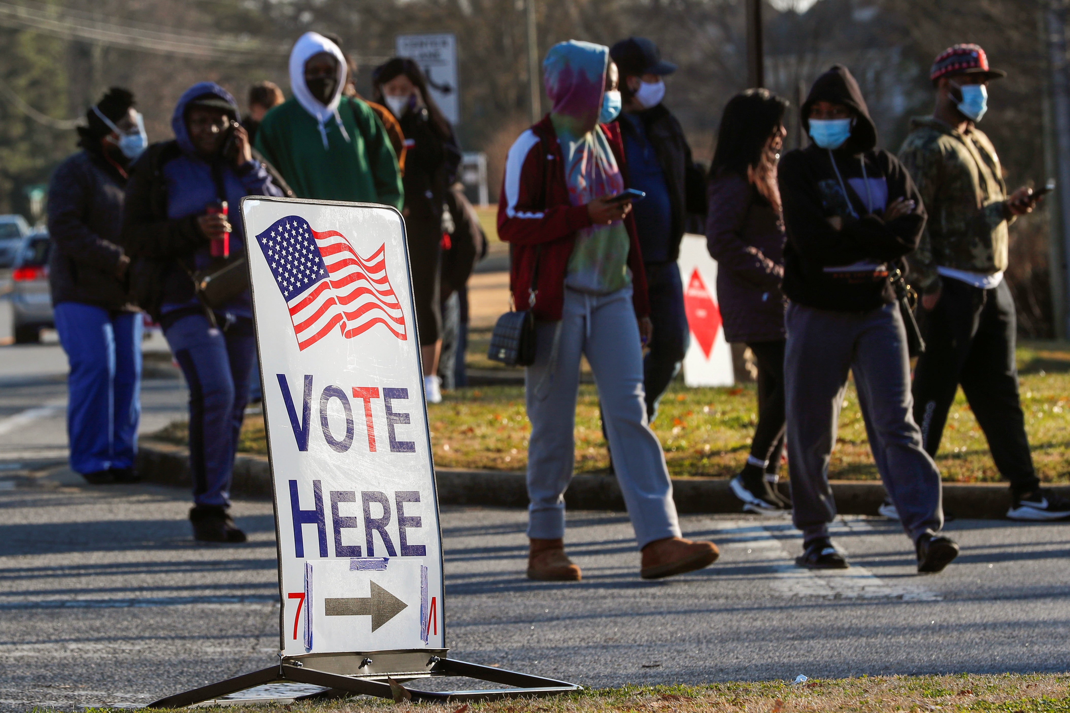 Voters stand in line during Georgia’s US Senate run-off election on 5 January.