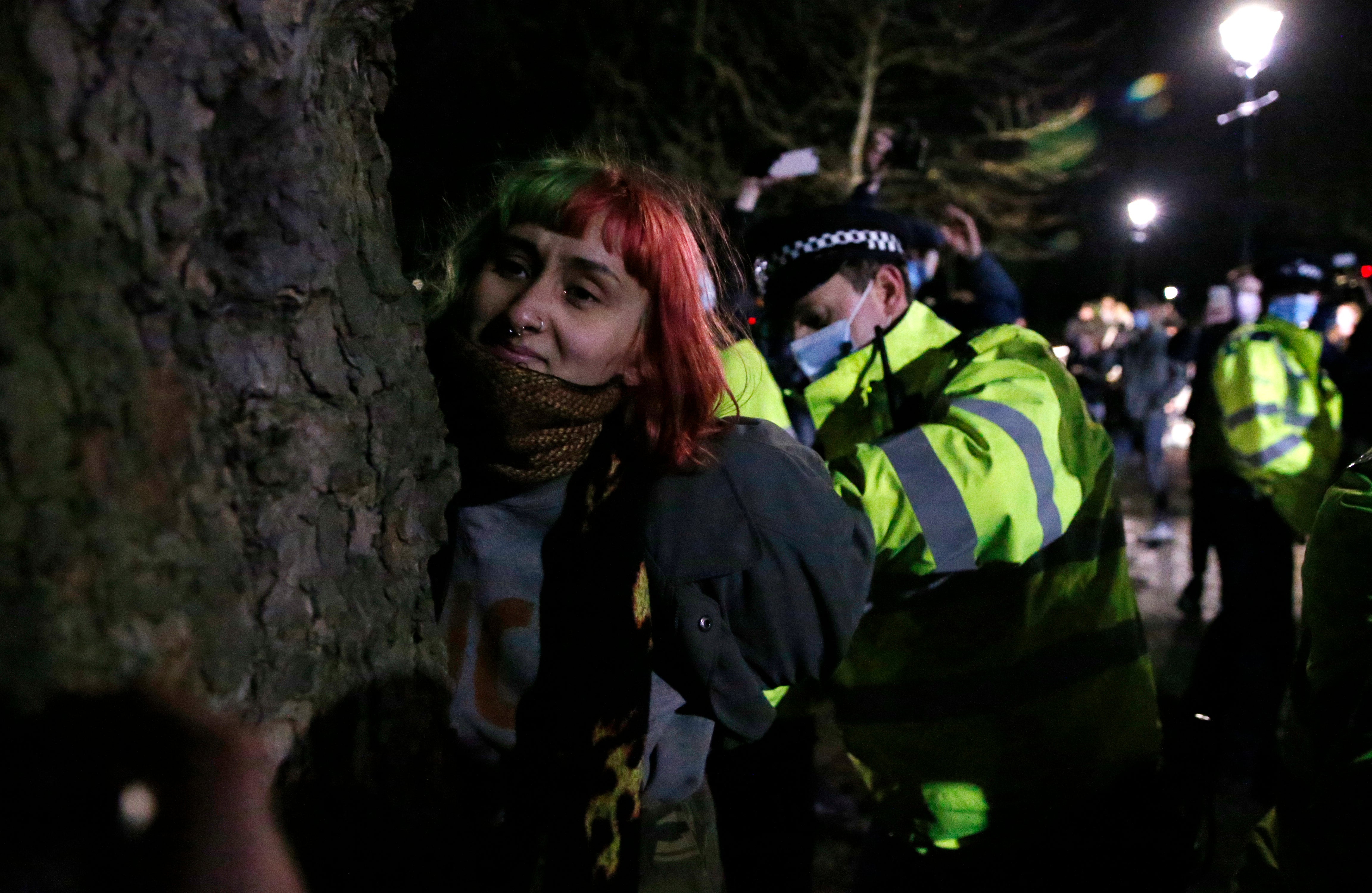 A woman is arrested during the 13 March vigil on Clapham Common