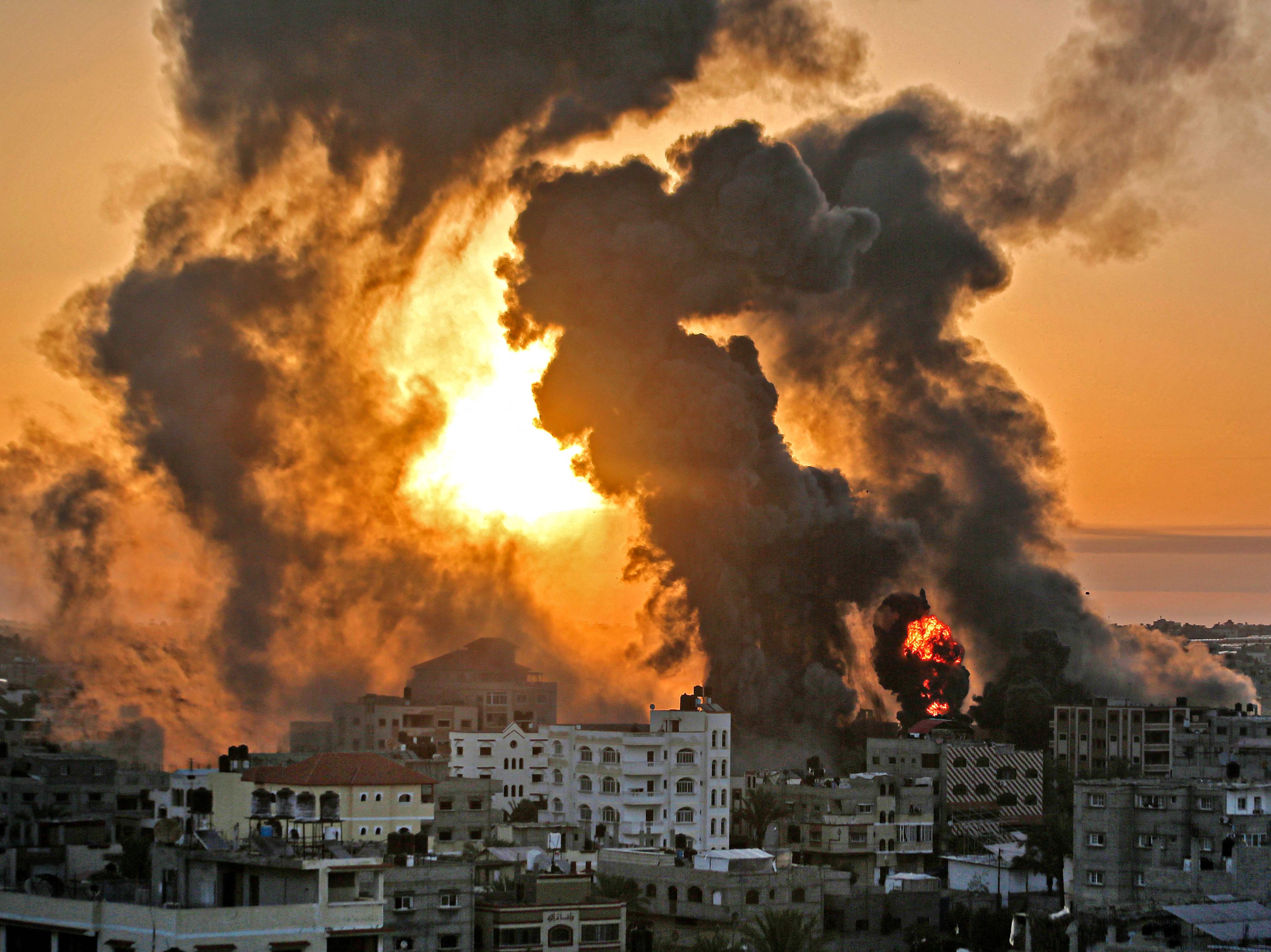 A fire rages at sunrise in Khan Yunish following an Israeli airstrike on targets in the southern Gaza strip