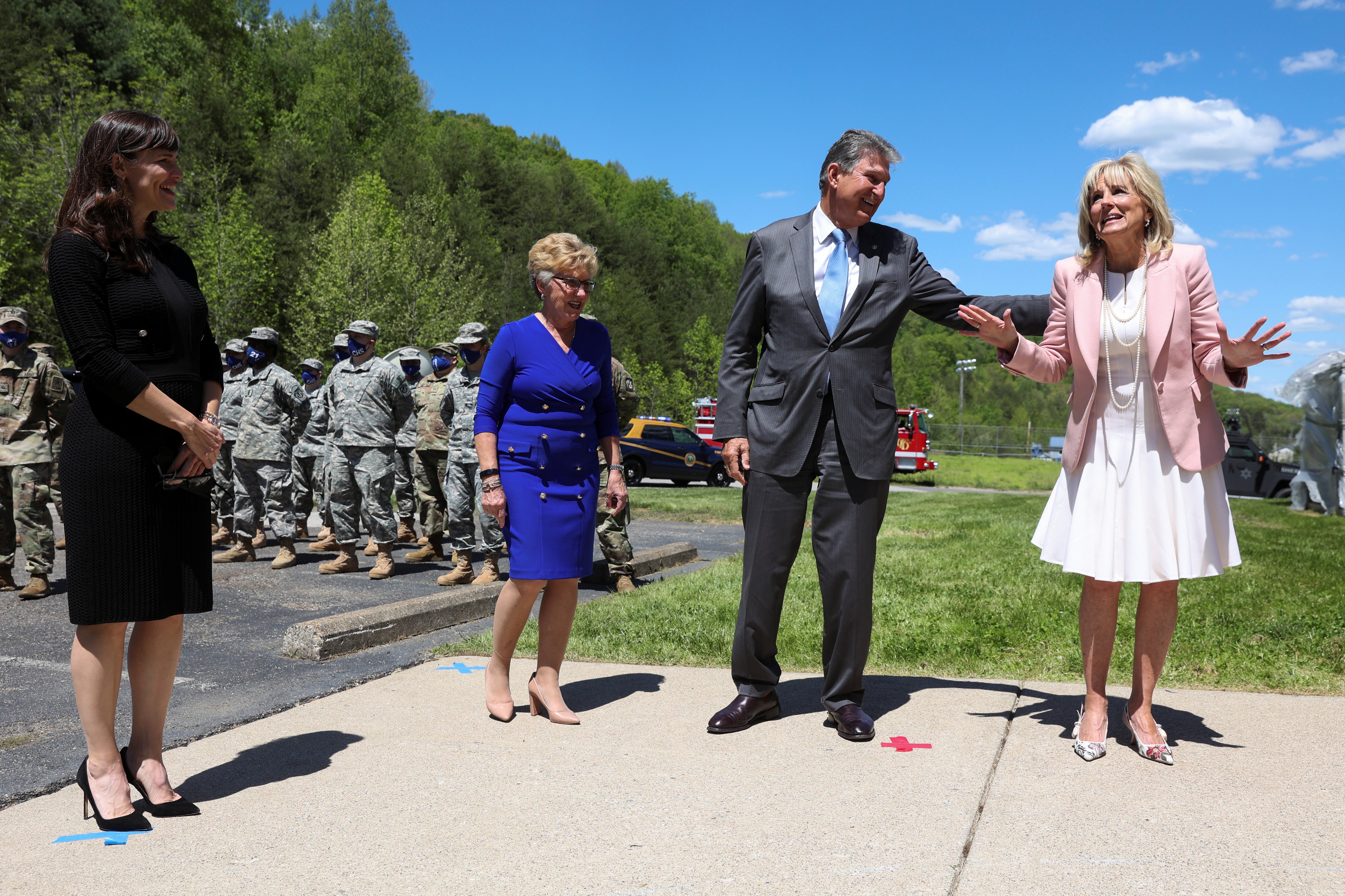 US First Lady Jill Biden greets members of the West Virginia National Guard with Senator Joe Manchin, his wife Gayle and actor Jennifer Garner during a trip to Charleston, W.V. on May 13, 2021.