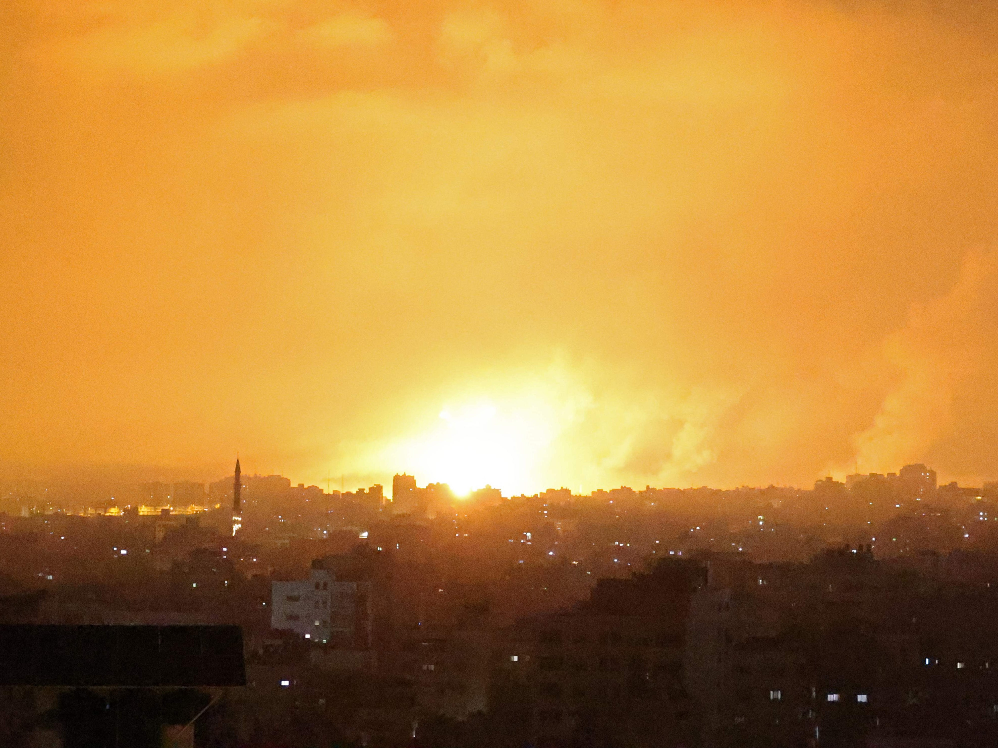 An explosion lights the sky following an Israeli air strike on Beit Lahia in the northern Gaza Strip