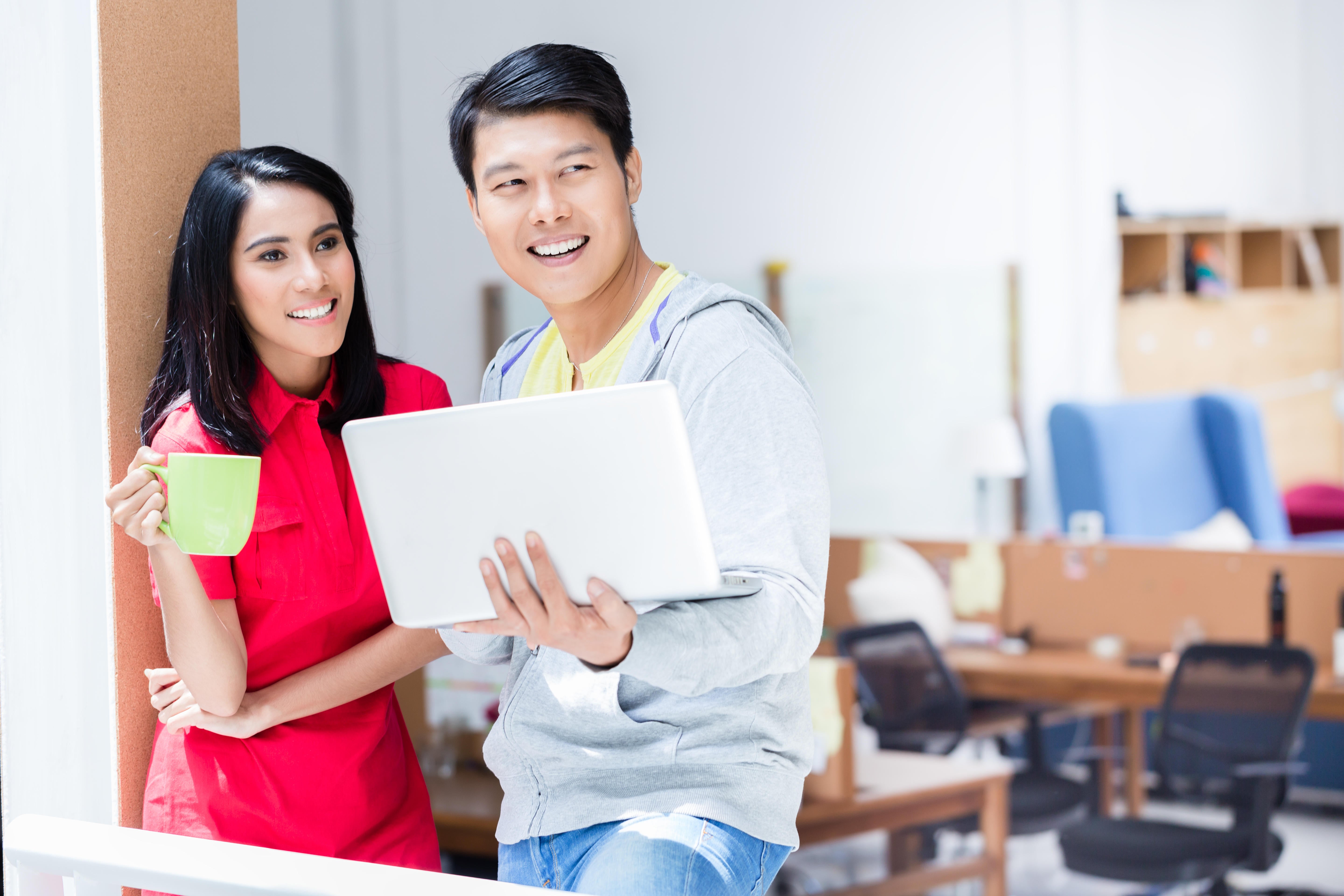 man and woman in an office discussing work plans