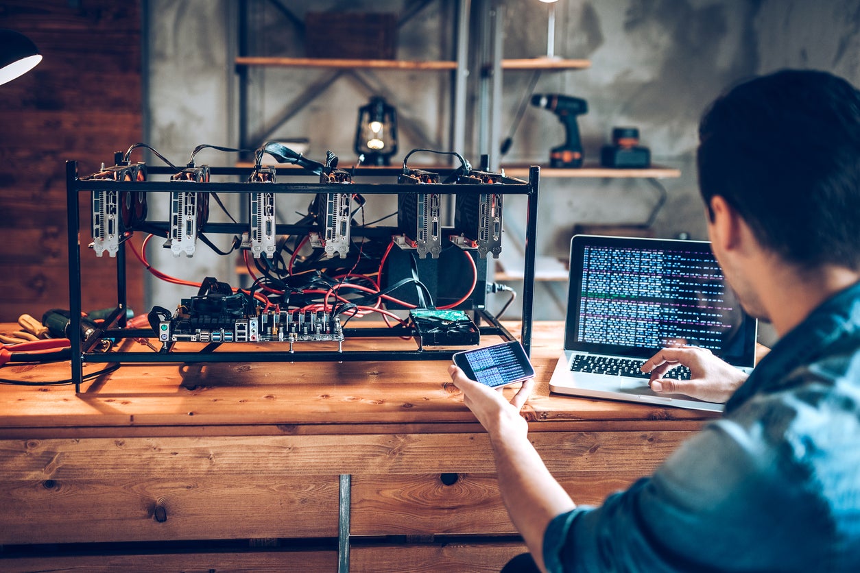 A programmer prepares a Bitcoin mining rig