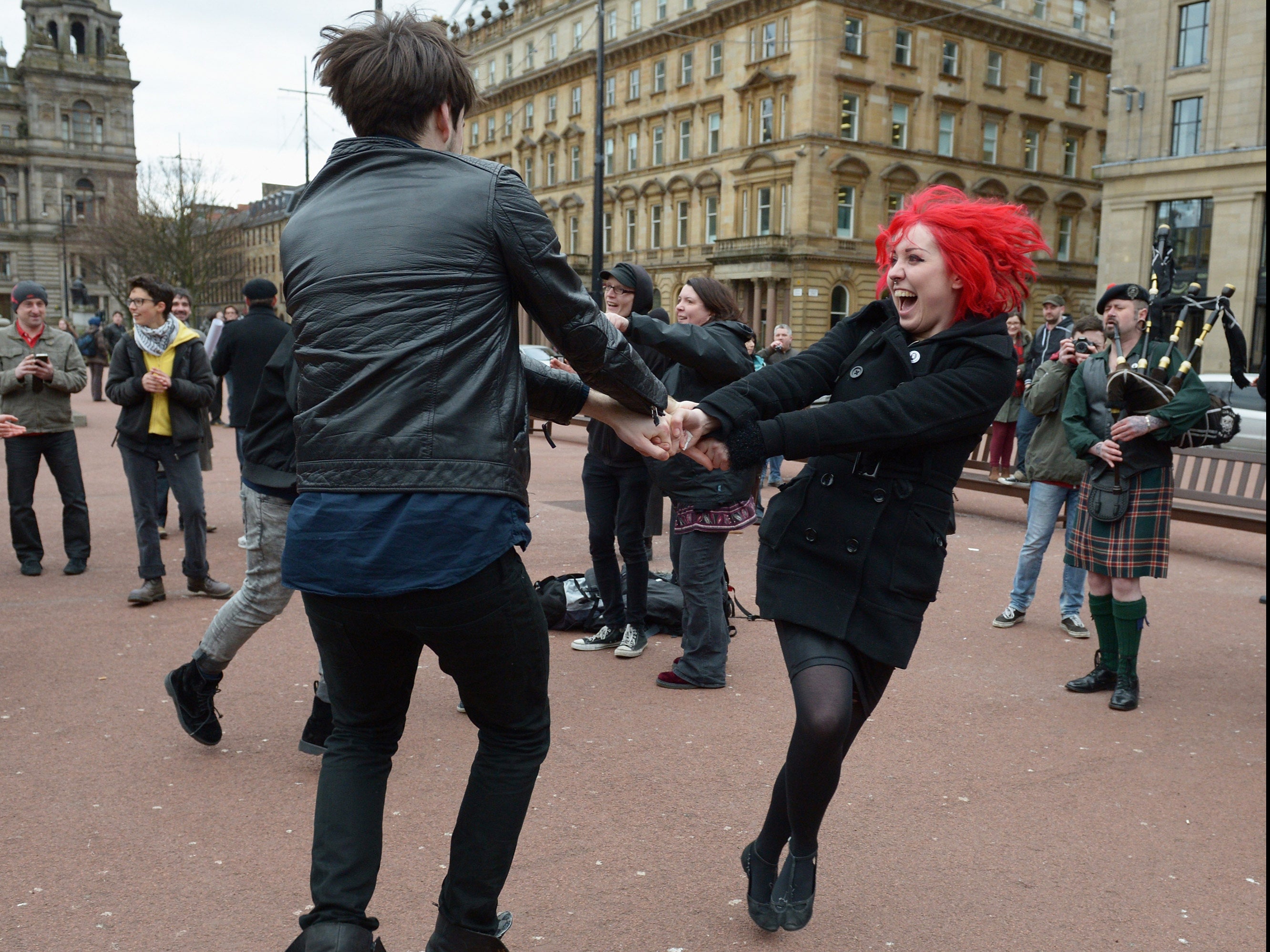 Members of the public dance in George Square, Glasgow, to mark the death of Baroness Thatcher on 8 April 2013